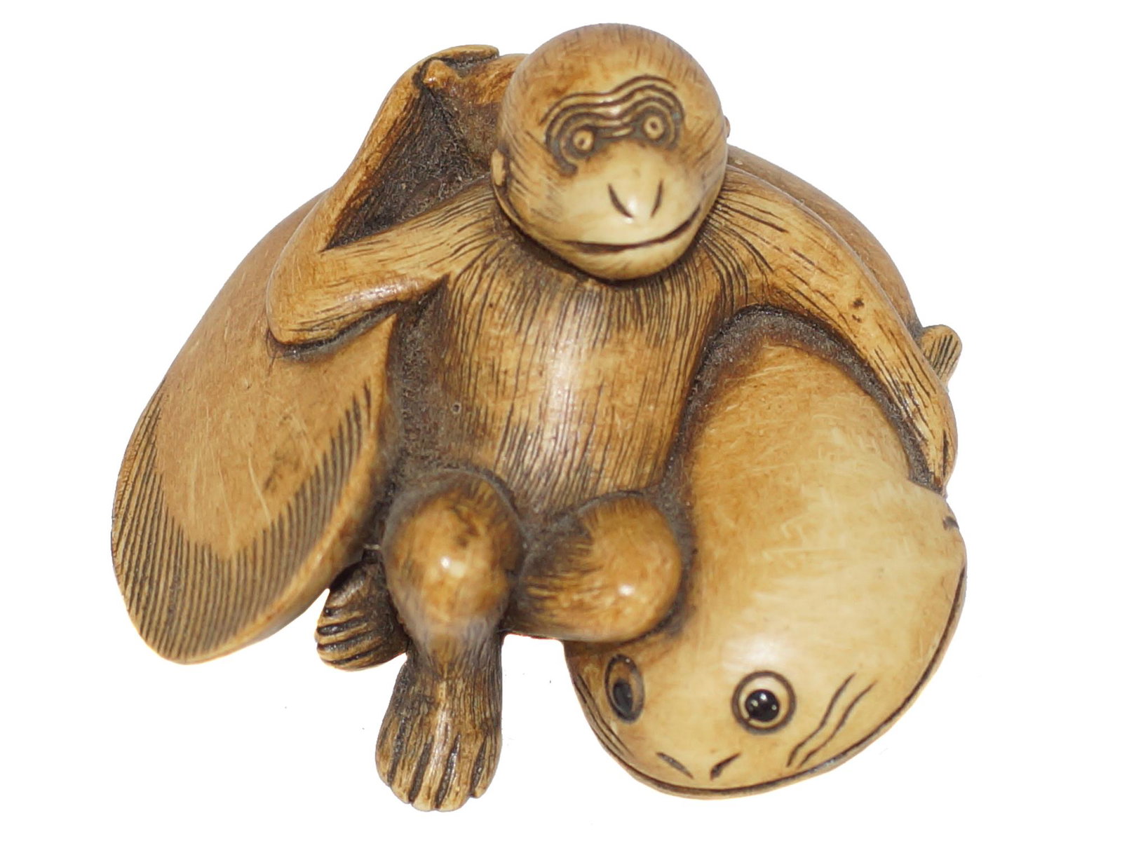 A VINTAGE CARVED NETSUKE OF A MONKEY AND CATFISH: A vintage netsuke of a monkey and a catfish, by Hidemasa. Marked at the bottom PMS, stands for Peabody Maritime Society. Size: 2 X 2 X 1 in.