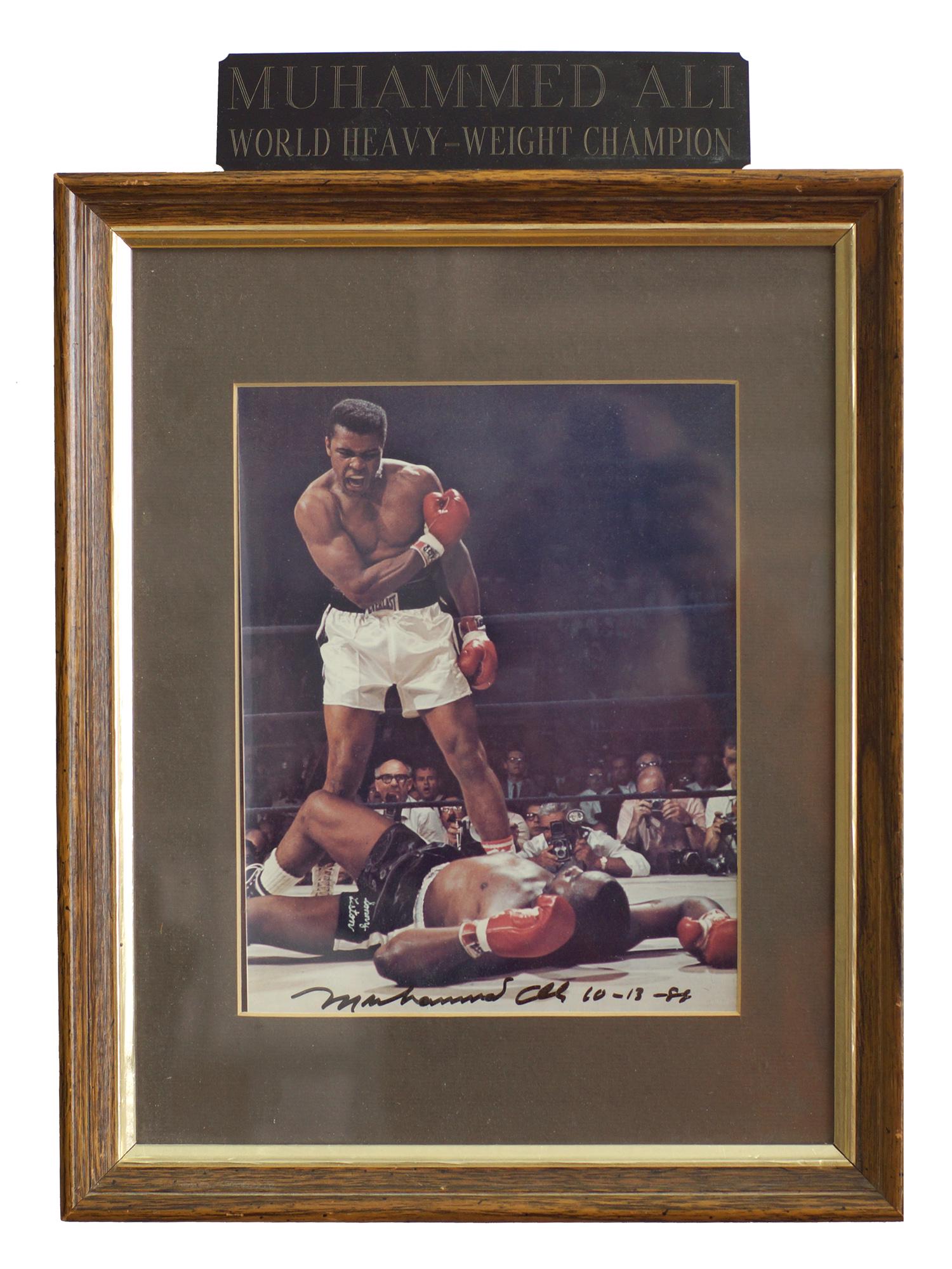 A 1988 MOHAMMED ALI AUTOGRAPHED PHOTOGRAPH: A 1988 Mohammed Ali World Heavyweight Champion photograph with autograph dated 10/13/1988. Dimensions: Size: 7.5 X 9.5 in. Frame Size: 13 X 16 in.