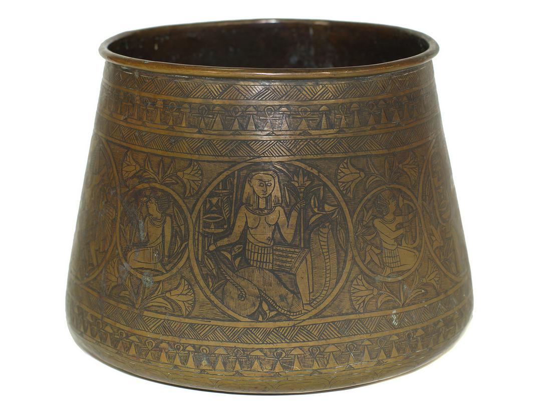 AN ISLAMIC ENGRAVED BRASS NORTH AFRICAN BOWL, 19TH CEN.: A hand-hammered brass bowl (vessel) of a conical form with engraved Egyptian figures depicting the life scenes of a pharaoh with characteristic geometrical and floral design around cartouches. Dimensi