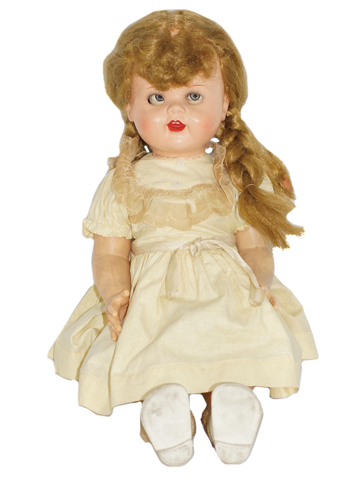ANTIQUE 1950's IDEAL DOLL: Antique 1950's hard plastic Ideal doll is wearing antique gown and shoes with blonde wig. Made in the USA. Dimensions: L 23 in.