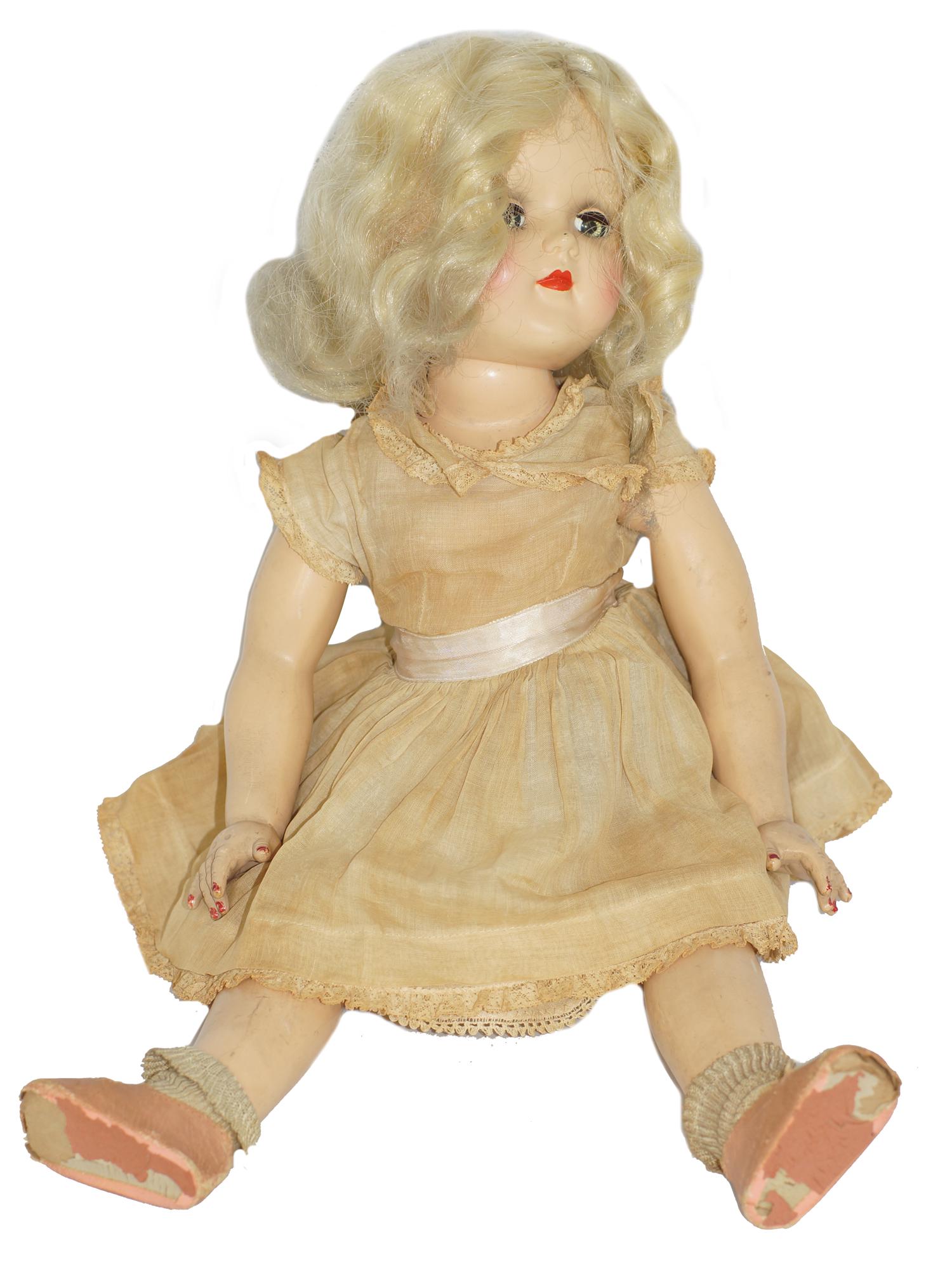ANTIQUE IDEAL TONI DOLL: The doll is made in the USA in the 1950's and marked p-93 Ideal Doll. The Ideal doll is hard plastic and is wearing a wig, lace dress, and antique shoes. Dimensions: L 21 in.