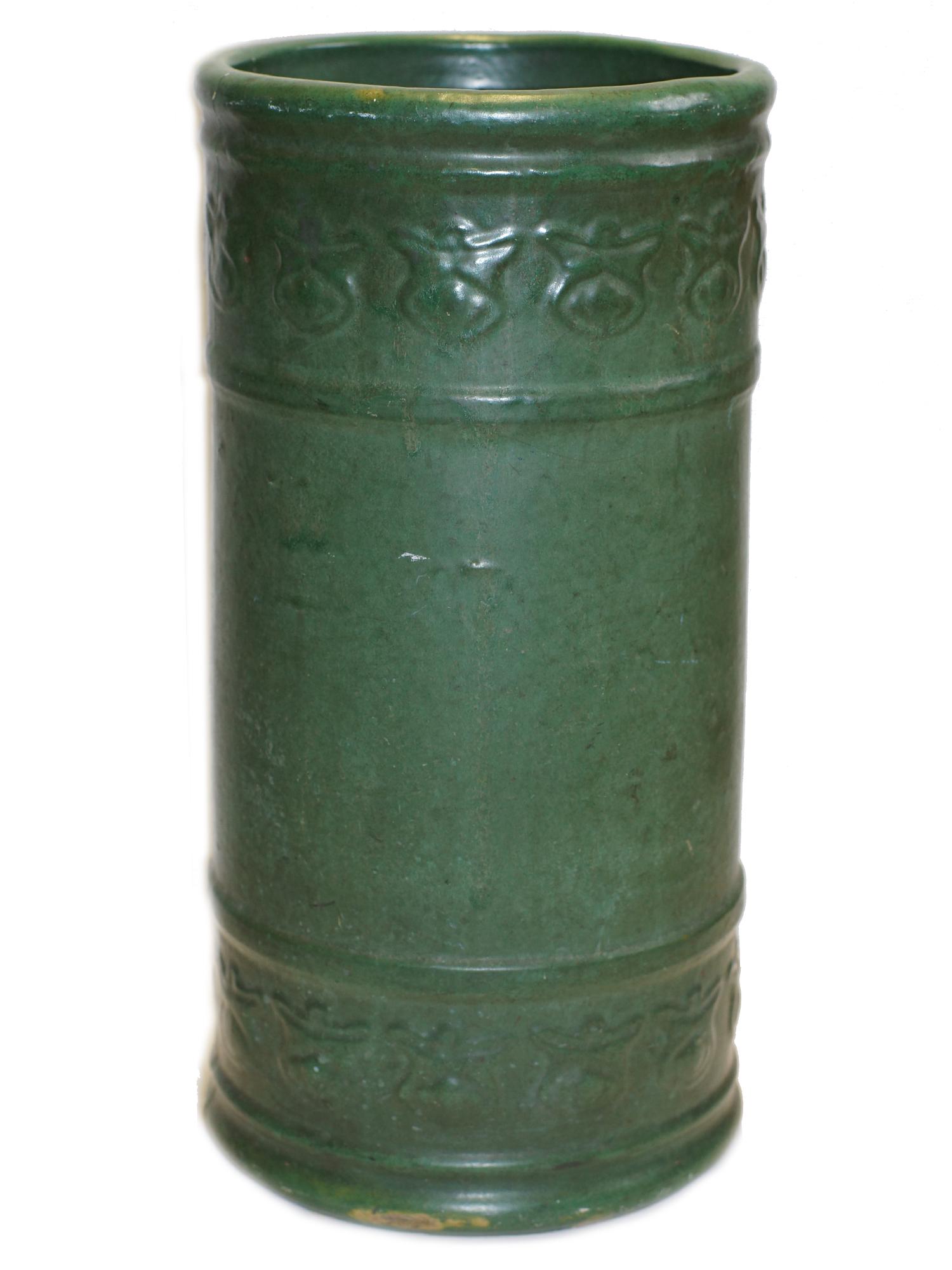 A WELLER POTTERY GREEN UMBRELLA STAND: A vintage green pottery umbrella stand. With embossed scarab-like decoration in matte green glazed-unmarked, possibly Weller. Dimensions: D 10 x H 20.5 in.
