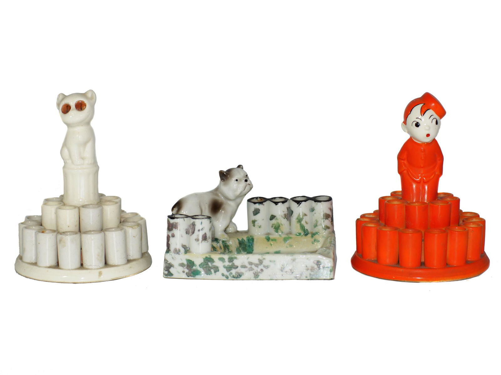 VINTAGE FIGURINE CIGARETTE/MATCH HOLDERS: First Item: Vintage white ceramic cigarette/match holder with orange-eyed cat figurine on the top. Unmarked by manufacturer. Second Item: Vintage Japanese Dog figurine ceramic cigarette/match holder.