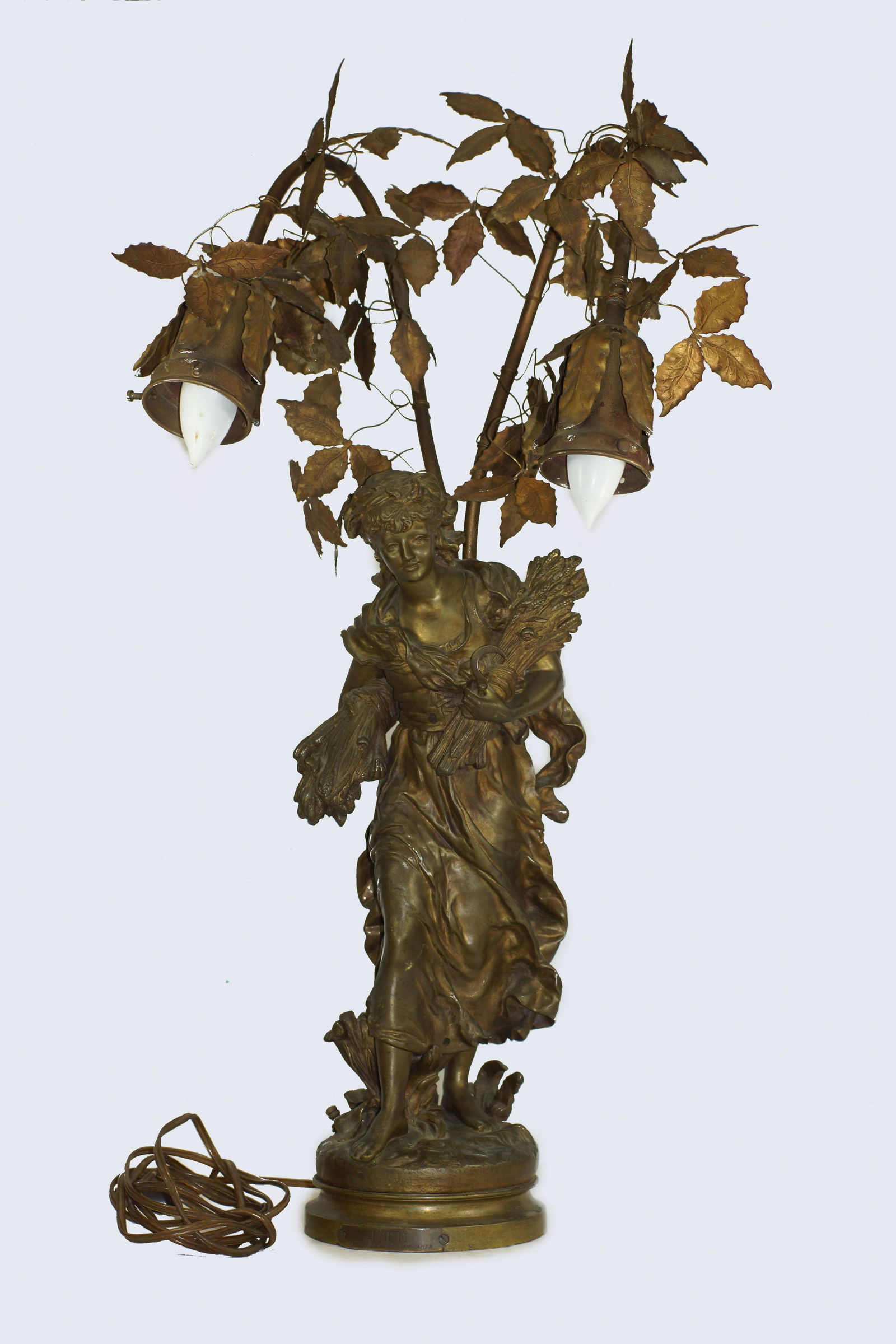 ANTIQUE LADY SPELTER FRENCH NOUVEAU BRONZE LAMP: A rare French antique art nouveau bronze lamp. Lady Spelter surrounded by leaves with two light sockets. Circa: late 19th century. Dimensions: H 27 in.