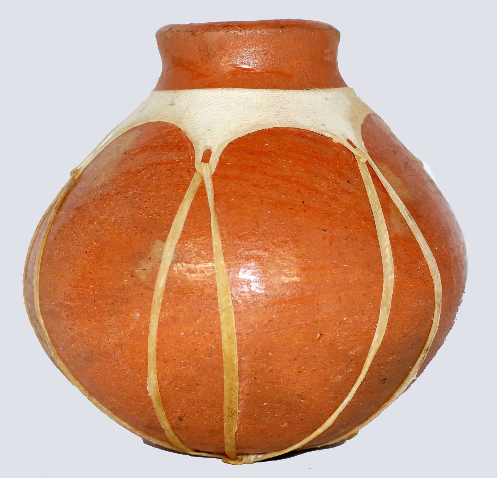 A CENTRAL ASIAN POTTERY OVERGRAZED POT: Probably of Afghanistan origin a hand-painted water vessel of a round form with white clay overlay design. Ca. late 19th - early 20th cc. Dimensions: H: 5.25 in.