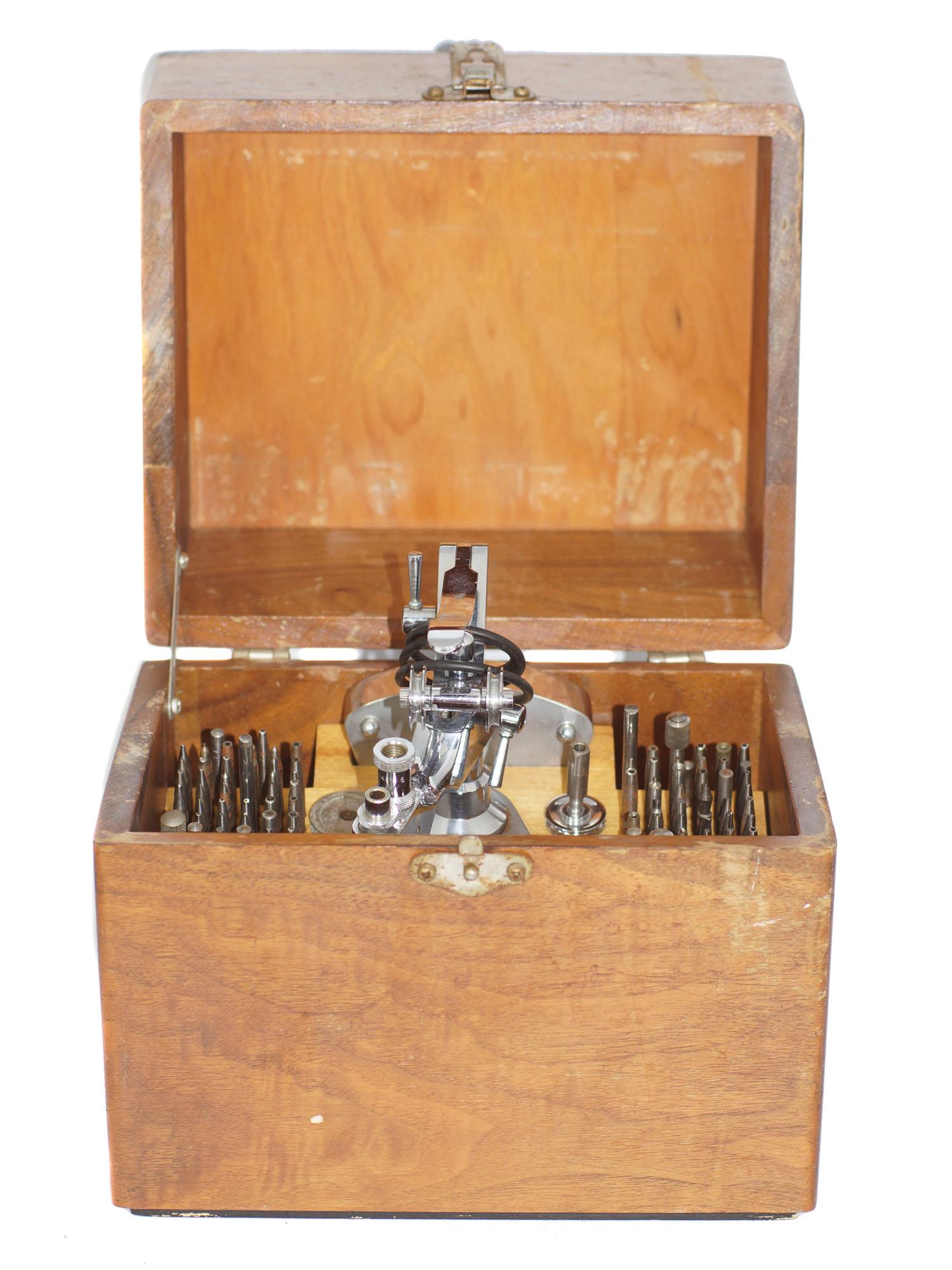 A RARE VINTAGE WATCHMAKING TOOL SET: A rare vintage staking tool set consists of a frame and dozens of "stakes", which are metal punches shaped to press fit, rivet, & form various parts of the watch. This example by C&E Marshall also fun