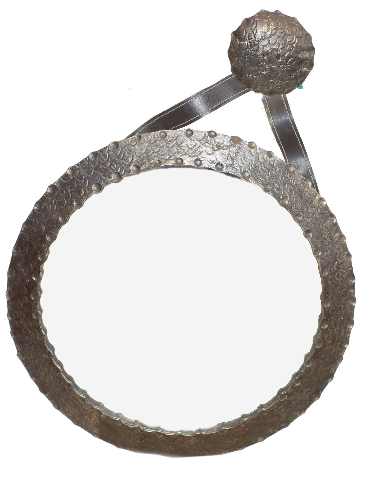 A VINTAGE MID CENTURY HAMMERED FRAME MIRROR: A vintage art and crafts round mirror with a steel hammered frame. Dimensions: Overall: D 24 in.