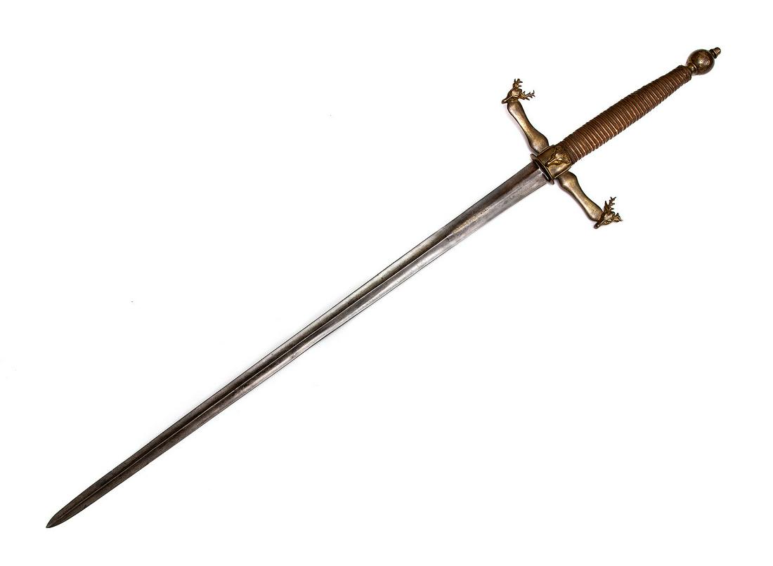 AN EXCEPTIONAL GERMAN HUNTING DOUBLE GRIP SWORD: The blade of this enormous hunting sword is forged in Medieval style with slogan in Latin "vive le roi" (long live the king) made with gold inlay on both sides. Large bronze cast crossguard with quill