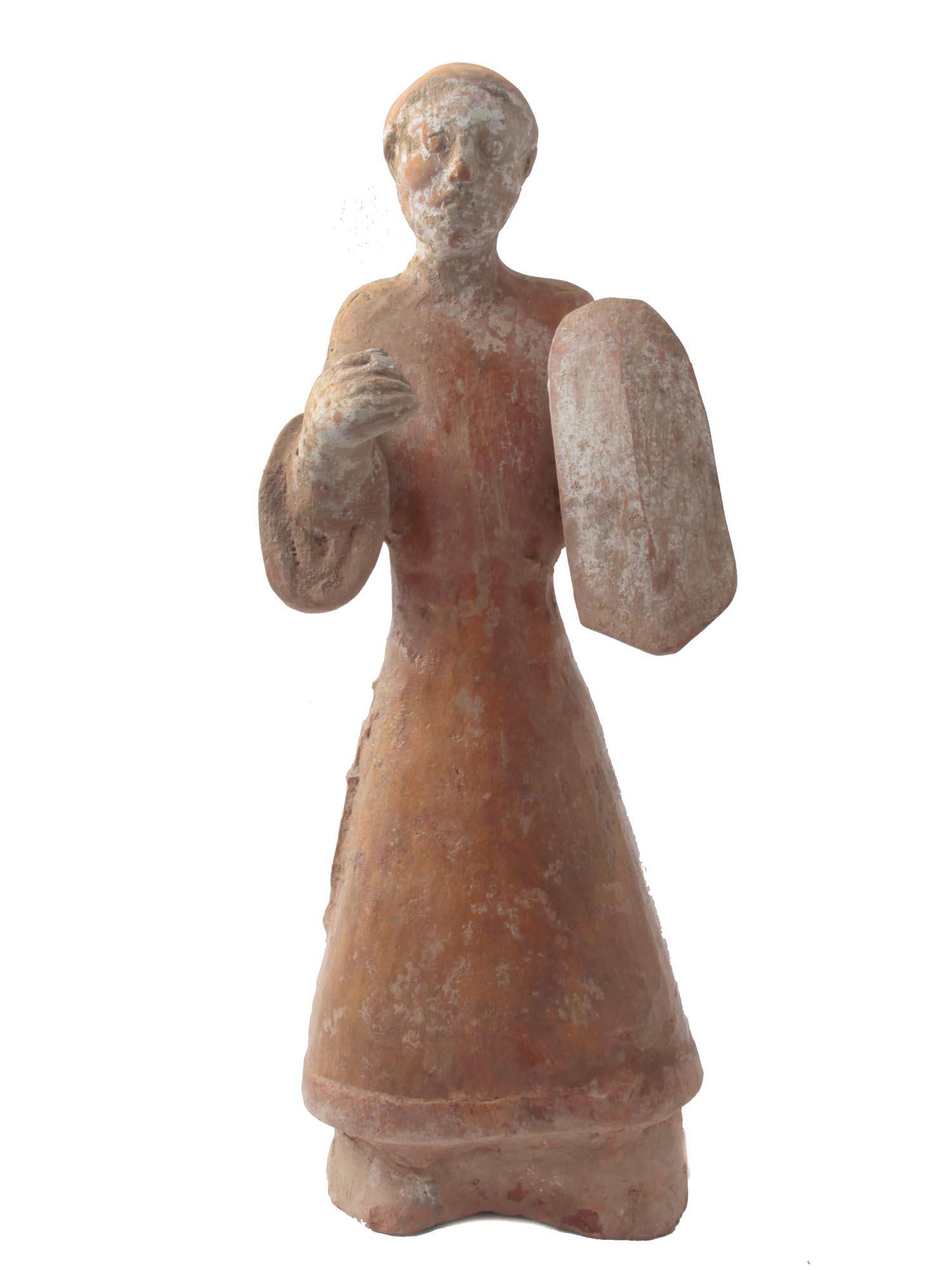 AN ANCIENT CLAY STATUETTE OF MOSES EUROPE: An antique statuette of Moses holding ten commandments. The figure is stylized, but with recognizable iconography. A dagger made in relief is attached to the clothes. The figurine is in good condition