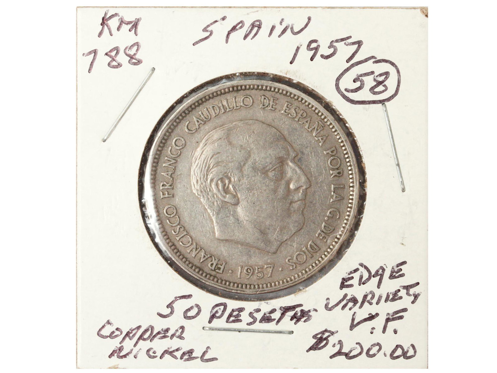 A SPANISH COIN: A copper/nickel Spanish coin valued 50 pesetas from the year 1957.