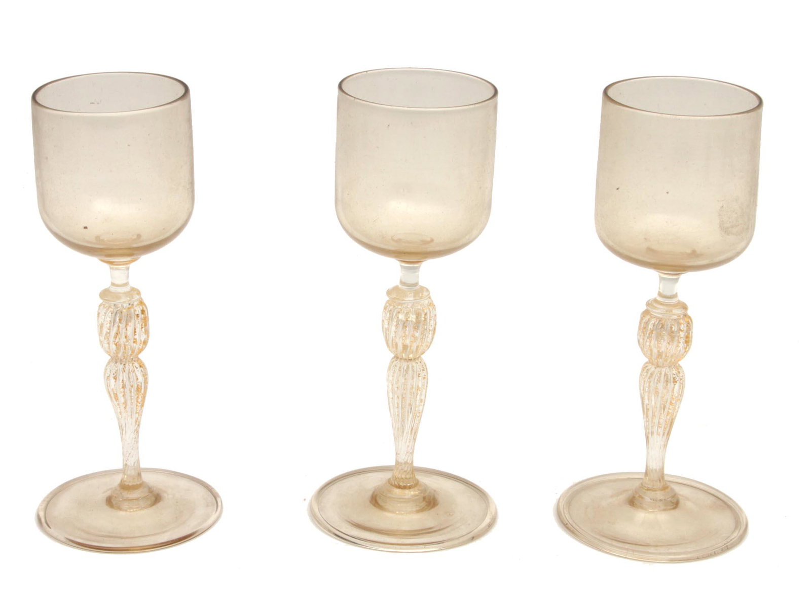A SET OF THREE WINE GLASSES LATE 19TH C: A late 19th century set of three light yellow wine glasses with beautiful fluted stems. Dimensions: H: 6 in., (15 cm.)