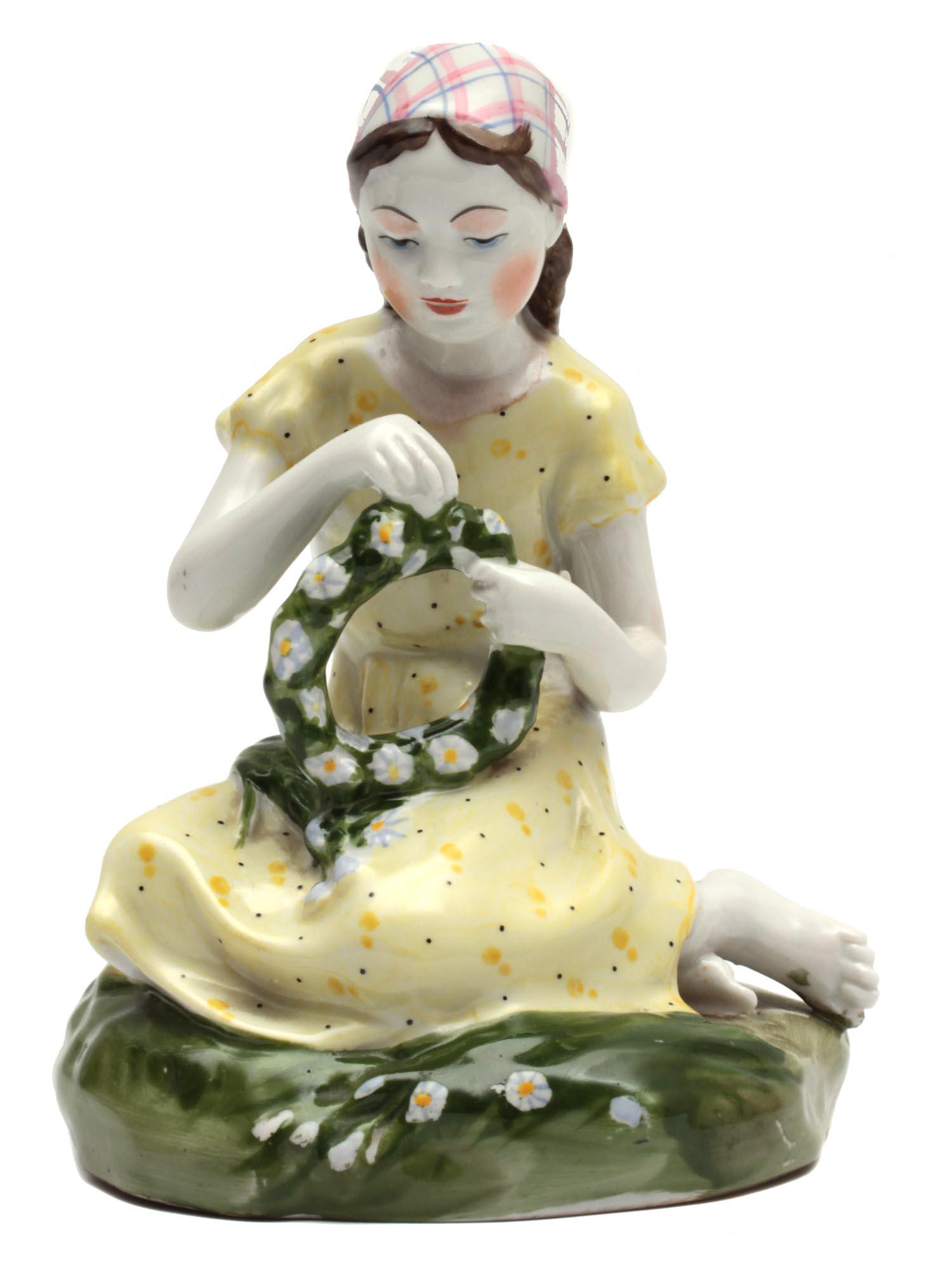 A VINTAGE SOVIET PORCELAIN FIGURINE: A porcelain figurine depicting a young girl weaving a wreath of daisies, sculptor Stolbova G.S. Leningrad Porcelain Factory. The figurine is very nice and neatly painted. On the base there is a brand