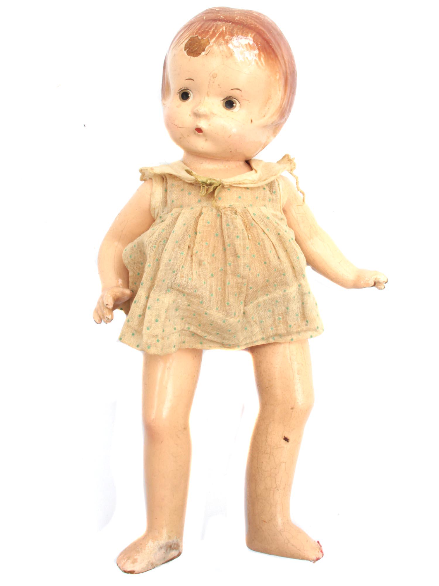 A VINTAGE AMERICAN PATSY JR DOLL BY EFFANBEE: An early 20th century Patsy Jr composition doll by Effanbee Doll Company. The doll is wearing a vintage outfit, has green eyes and painted open mouth. There are chips, scuffs, traces of use. Marked: "
