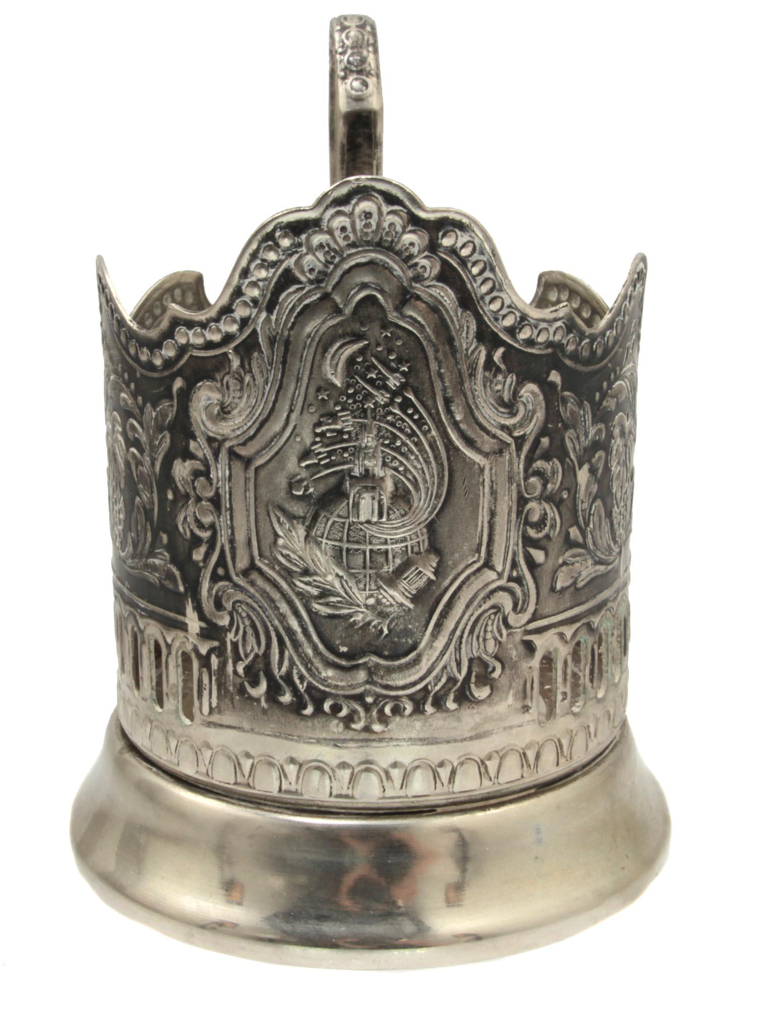 A VINTAGE RUSSIAN SOVIET TEA CUP HOLDER: A mid-century melchior Kolchugino tea cup holder. The cartouche depicts the Kremlin on the globe and several rockets flying into space. The cup holder is also decorated with a pattern of grape vines.