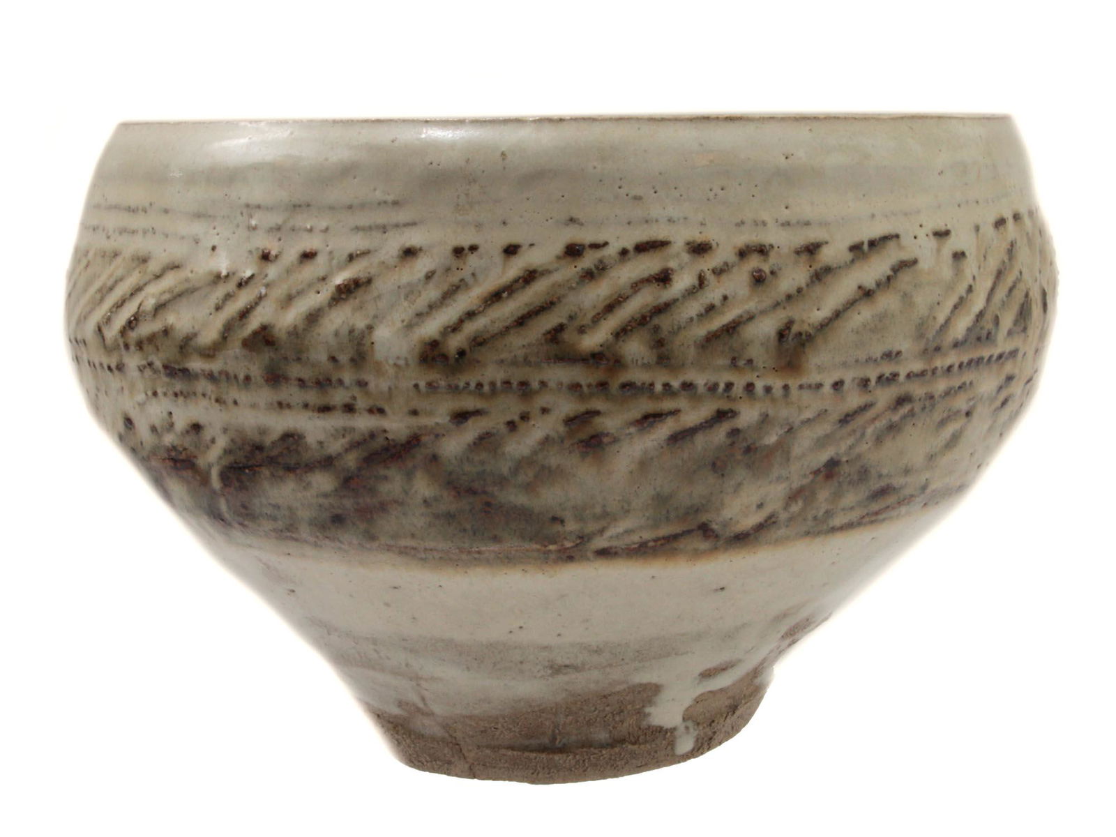 AN ANTIQUE CHINESE GLAZED POTTERY BOWL: A Chinese pottery bowl covered with a pale green glaze and decorated with an embossed pattern of a series of stripes on the sides of the bowl. Marked with a Chinese hieroglyph on the bottom. Dimension