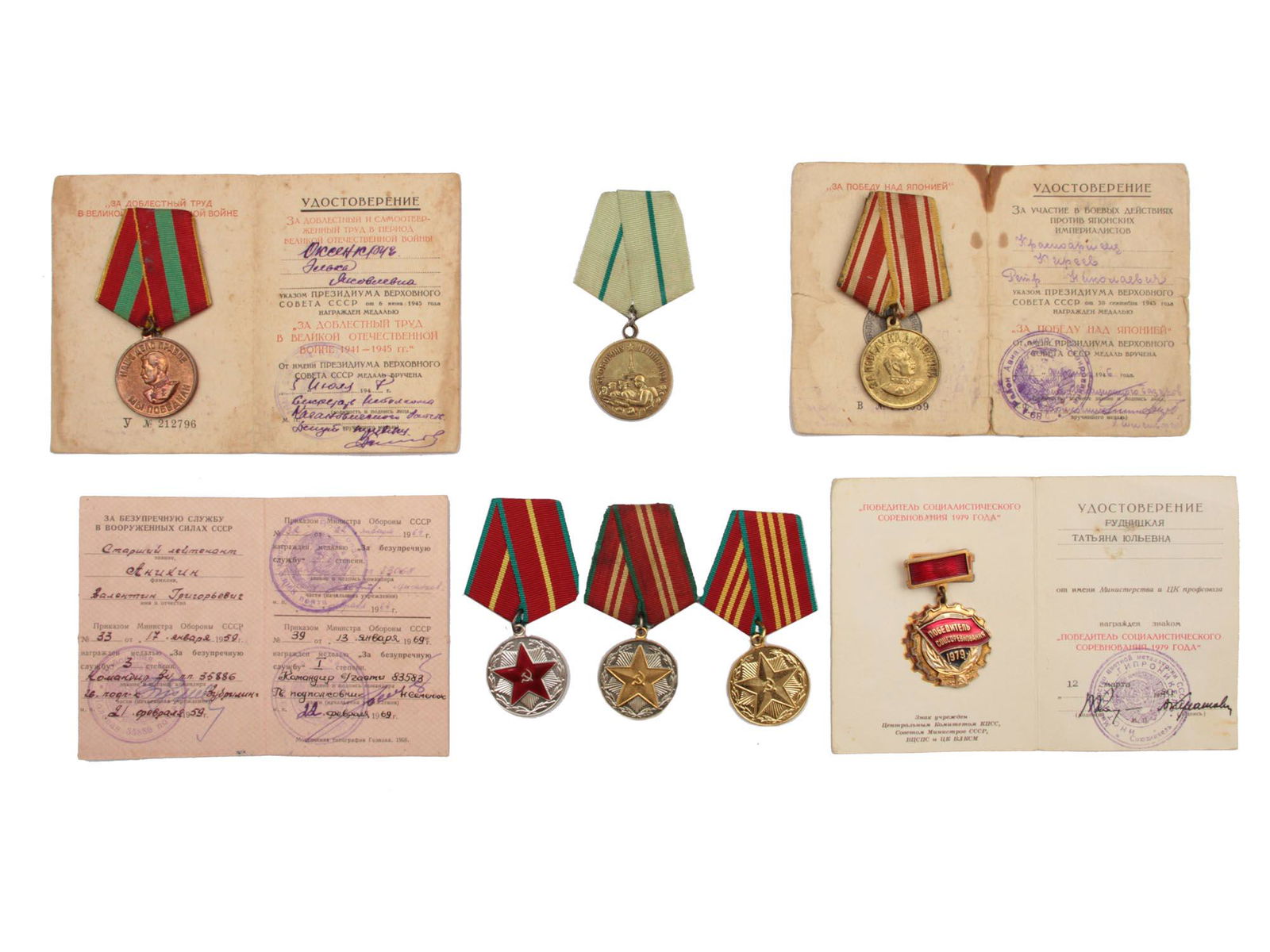 A DOCUMENTED GROUP OF SOVIET MEDALS AND AWARDS: The lot includes: a medal "For Valiant Labor in the Great Patriotic War" with documents in the name of the Oksenkrug Elka Yakovlevna, a medal "For Victory over Japan" with documents in the name of Pet