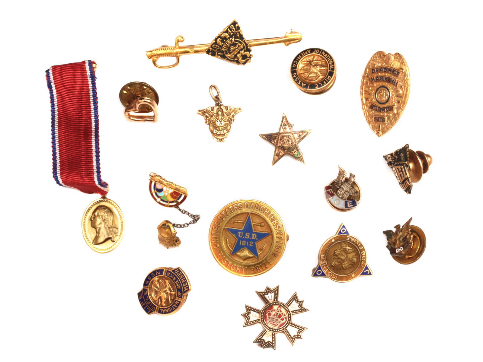 A GROUP OF GOLD FILLED MILITARY PINS AND BADGES: A lot of 15 gold filled and enamel pins and badges. Two USNA naval academy pins and one tie pin. Dragnet mark VII Dean 714 badge. Two national rifle association enamel pins. And others. All gold fille