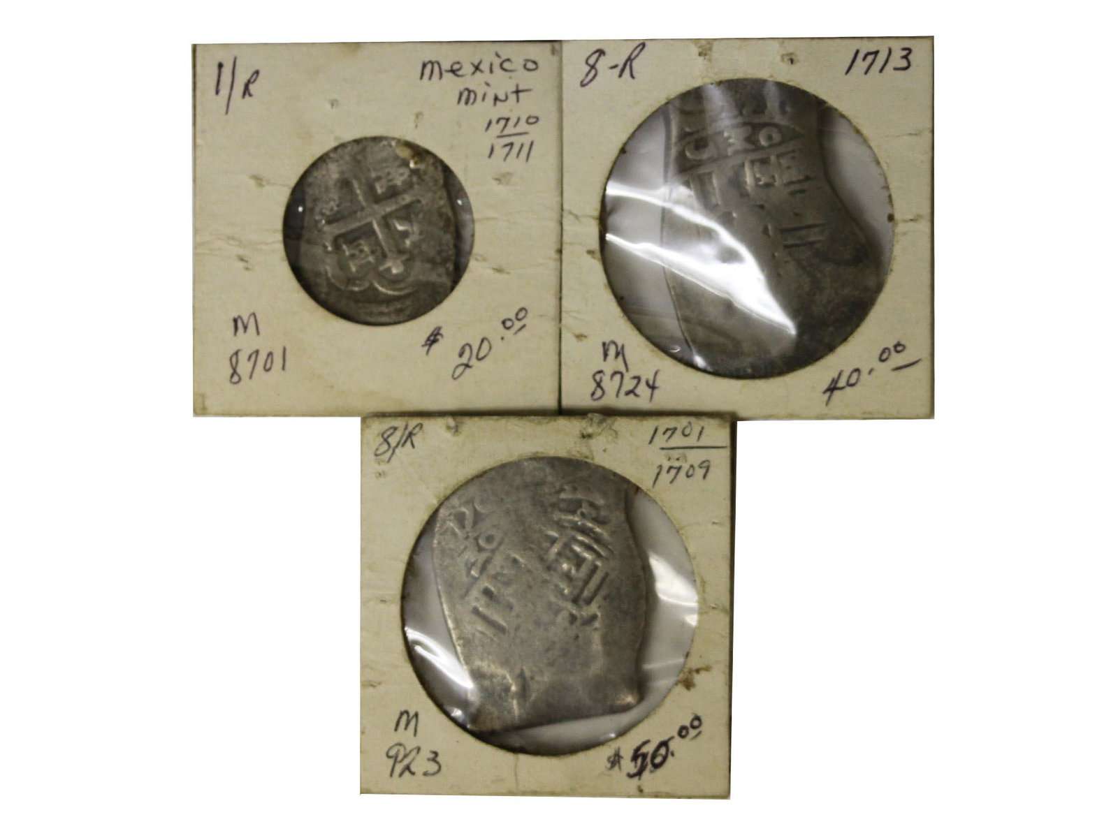 A SET OF THREE ANTIQUE MEXICO SILVER REALES COIN: A lot of three silver coins. Mexico SPANISH COLONY 8 Reales 1701. Mexico SPANISH COLONY 8 Reales 1713. Mexico SPANISH COLONY 1 Reales 1711. Total weight: 64.5 g. Dimensions: Various dimensions.