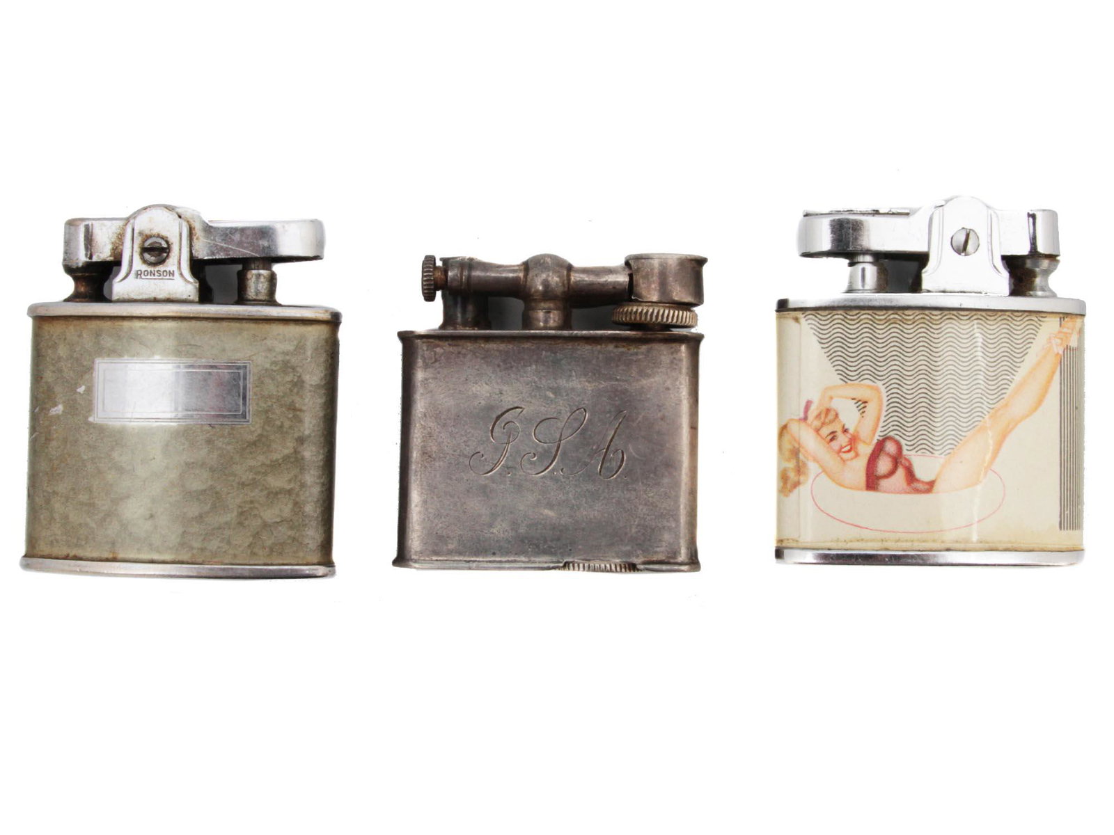 A LOT OF THREE LIGHTERS INCLUDING STERLING SILVER: A lot of three lighters that consists of one Ronson petrol lighter made in Newark U.S.A, one sterling silver Tellus lighter made in Mexico engraved with initials G.J.A, and one is a vintage Pin Up Gir
