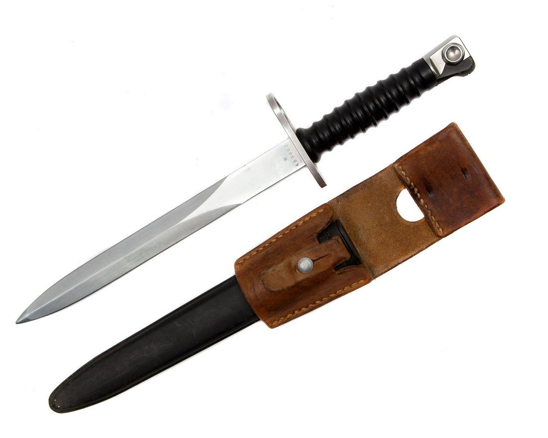 A SWISS BAYONET KNIFE M1957: Bayonet for Sturmgewehr 57 Rifle manufactured by the SIG (Schweizerische Industrie-Gesellschaft). Plastic ribbed handle, double edged blade marked with S/N W463462 and maker's logo, original frog embo