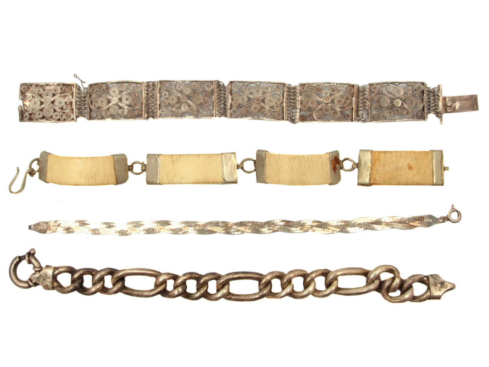 A SET OF FOUR VINTAGE SILVER BRACELETS: This assortment of bracelets is a very rare collection, includes a fine silver bracelet European style, a unique 925 silver braided bracelet made in Italy, among others. All of them circa 20th century