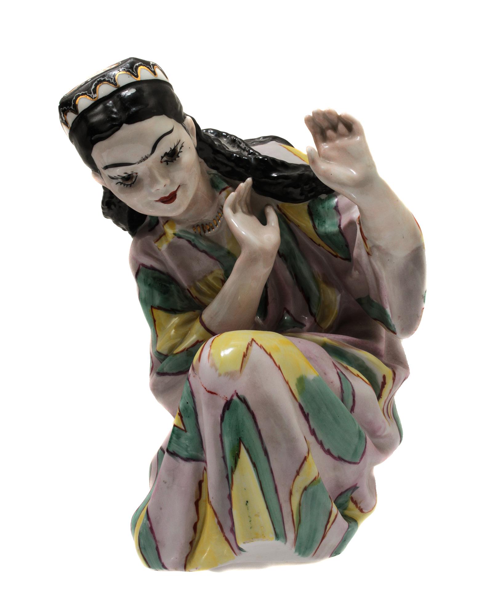 AN EARLY SOVIET PORCELAIN UZBEK FIGURINE: Ð Russian porcelain figurine "Uzbek girl" with a dancing Uzbek girl in a traditional patterned costume. With the hallmark of the Polonsk art ceramics plant on the base. Sculptor O. Rapai. There are s