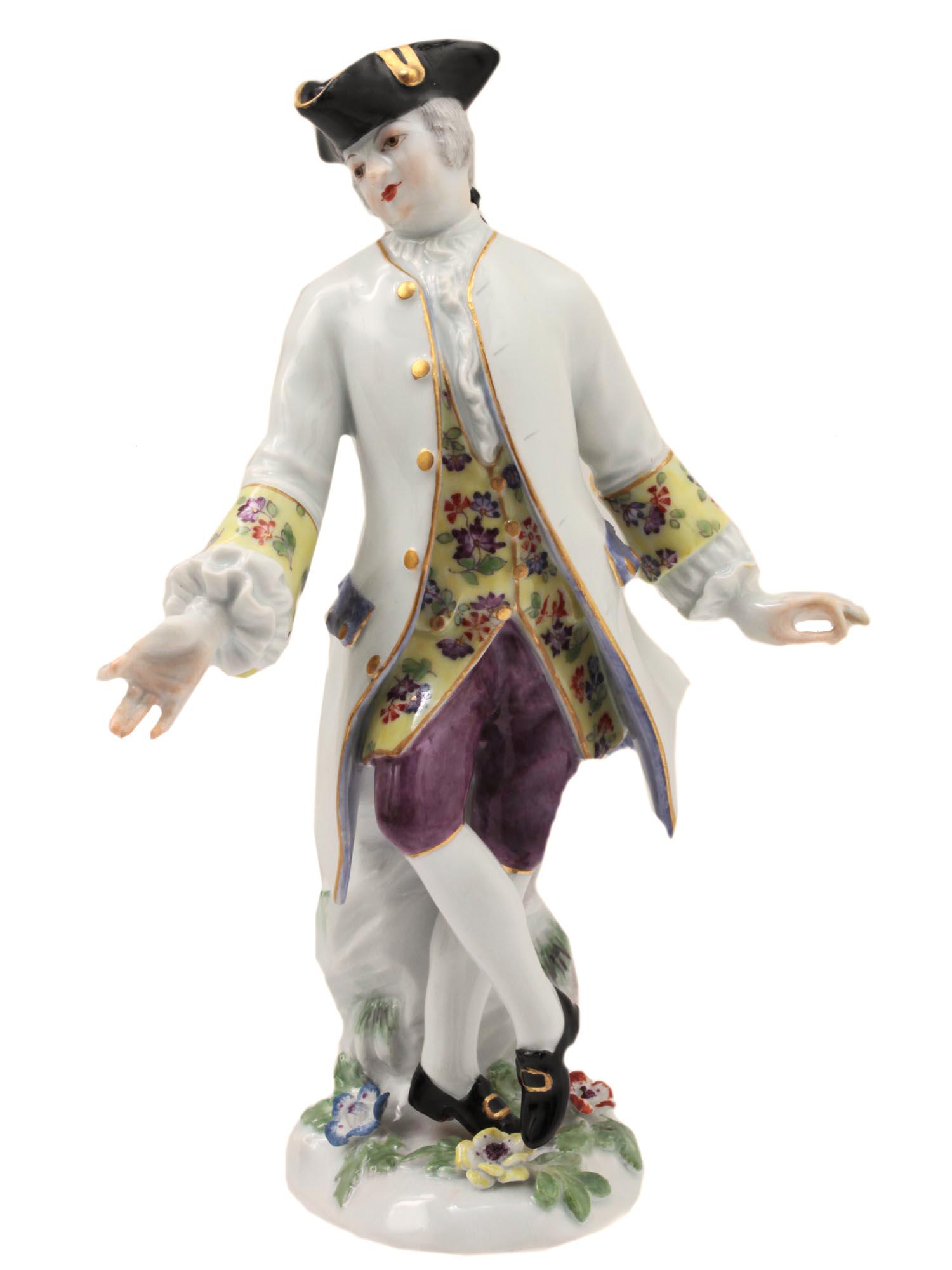 A MEISSEN FIGURINE OF A DANCING GENTLEMAN CA 1745: A figurine of an exquisitely dressed dancing gentleman modelled by KÃ¤ndler. The gentleman wears a black cocked hat, an elongated milky camisole with patterned trim on the sleeves, a pale yellow ves