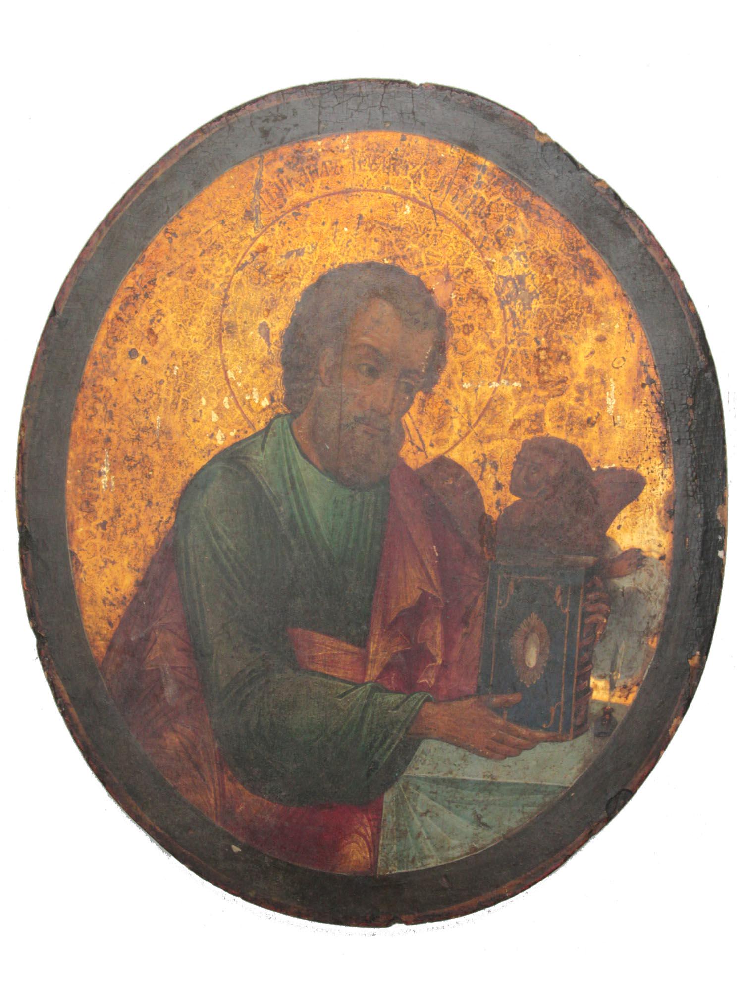 AN ANTIQUE RUSSIAN ICON OF MARK THE EVANGELIST: An antique Russian icon depicting St. Mark the Evangelist with the Gospel Book and the lion. Egg tempera on wood with gilding. Circa: late 18th to early 19th century. Dimensions: 14 x 12 in.