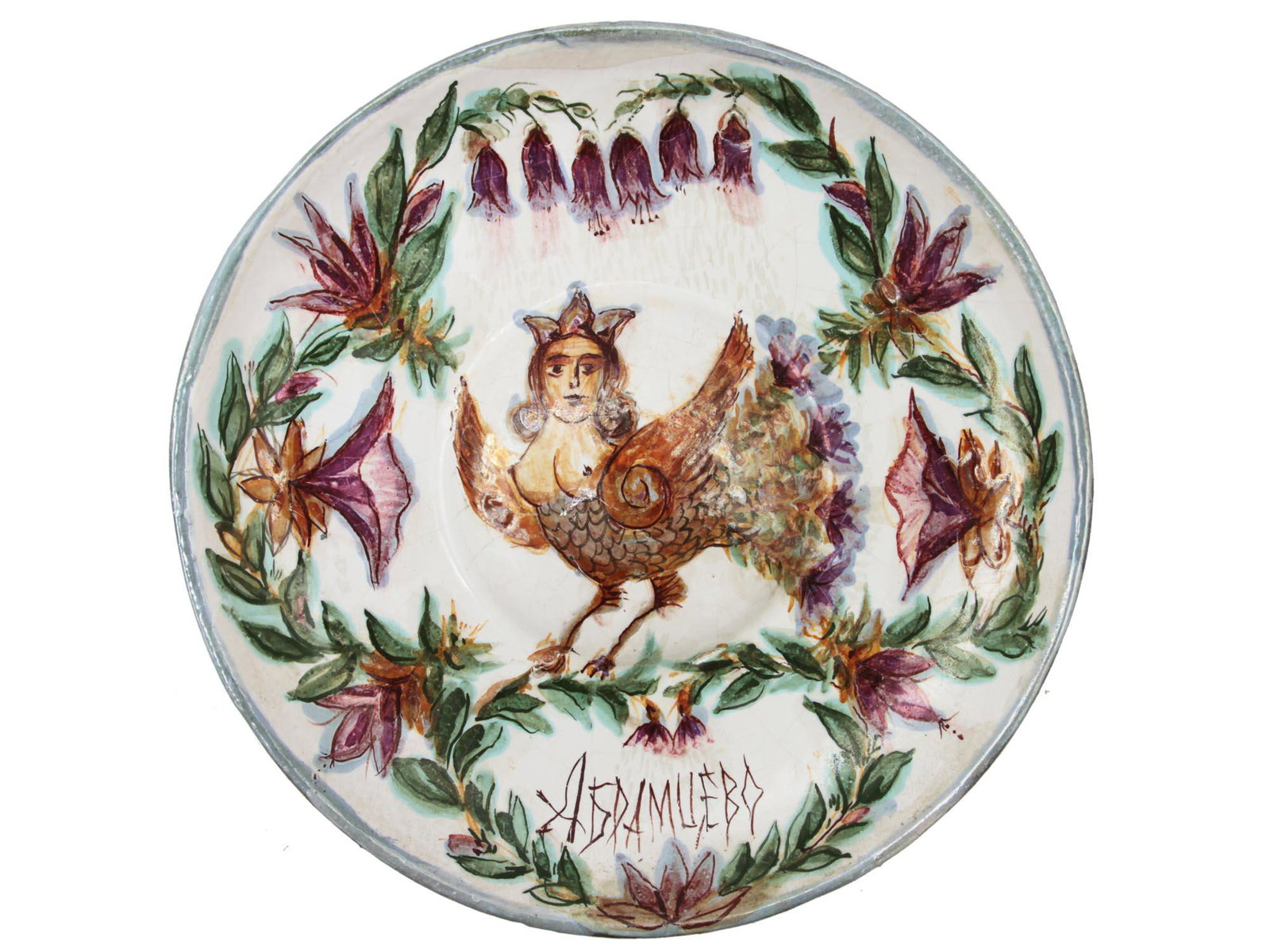 A RARE ANTIQUE RUSSIAN CERAMIC PLATE ABRAMTSEVO: A hand-painted wall plate depicting the bird of paradise Sirin surrounded by flowers. Sirin is the image of a bird with the head of a girl from Slavic legends. The artists of the Abramtsevo workshop o