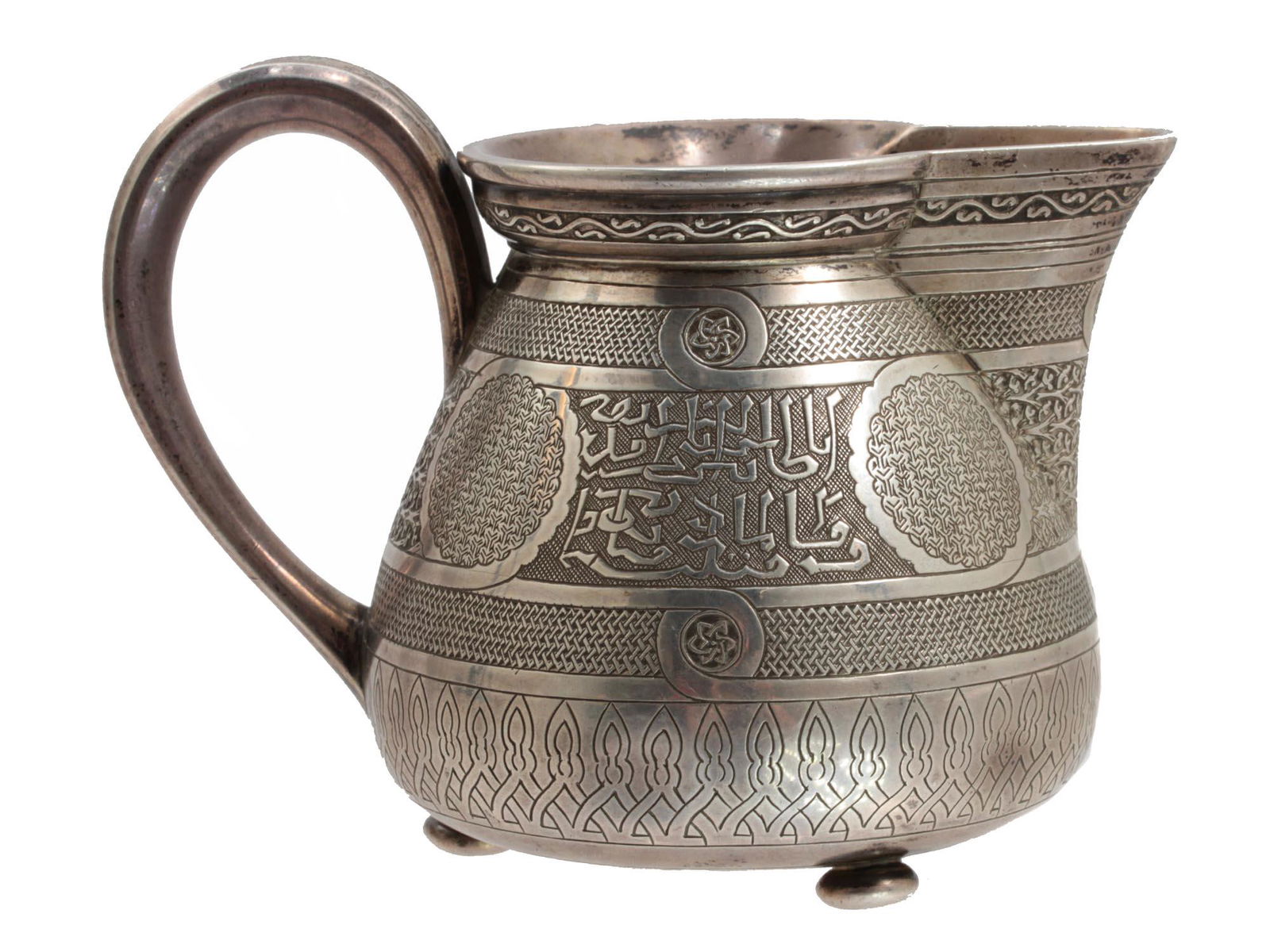 AN IVAN KHLEBNIKOV RUSSIAN SILVER CREAMER 19TH C: A delightful Russian silver creamer in the style of the Ottoman Empire. Decorated with engraving depicting fine detailed Islamic motifs, geometrical patterns and calligraphic inscriptions. Marked with