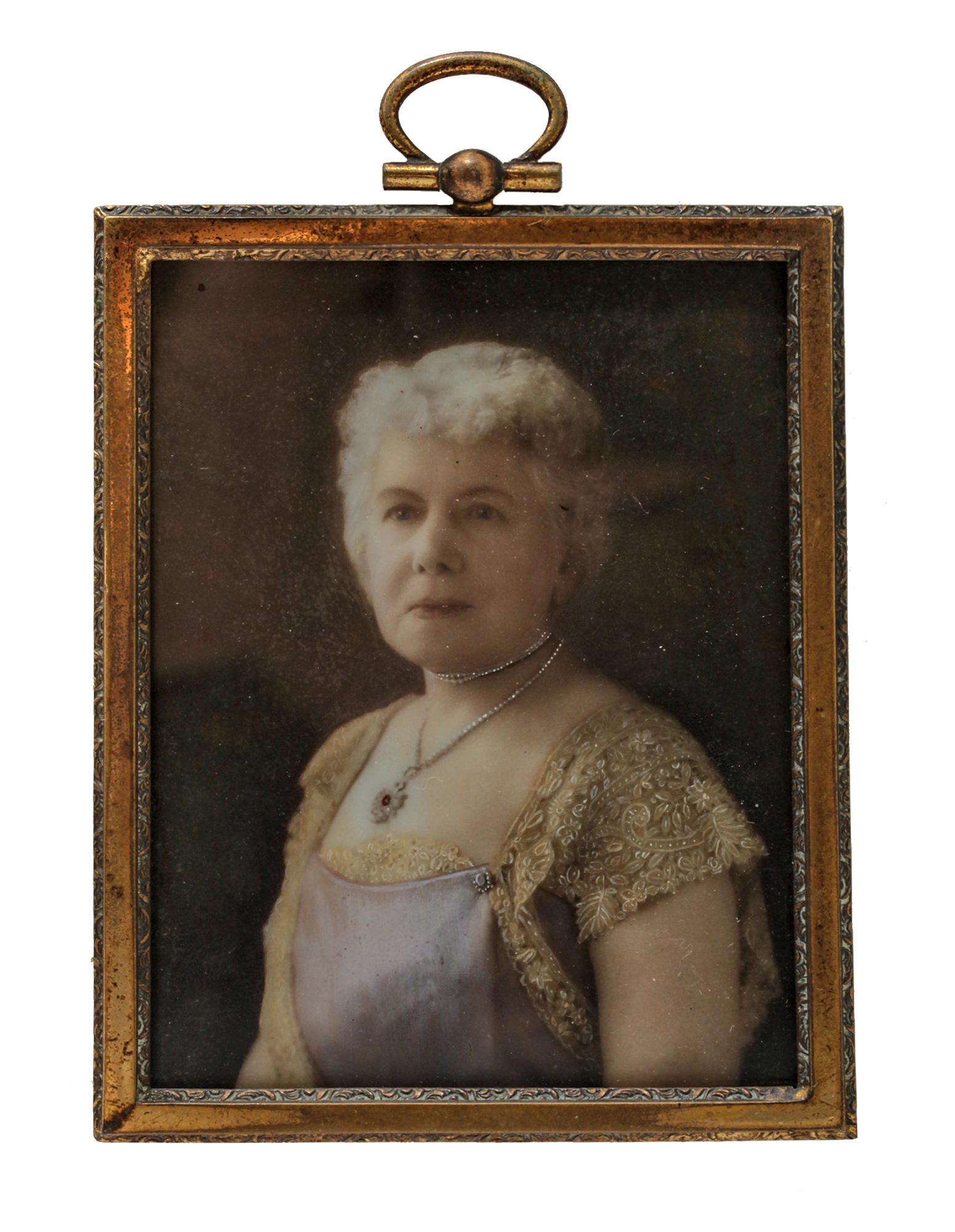 AN ANTIQUE VICTORIAN RUSSIAN MINIATURE PAINTING: A Russian Victorian miniature painting with a portrait of an elderly lady wearing a beautiful dress. The painting is framed in a graceful frame with a hanging ring; the back is covered with cherry vel