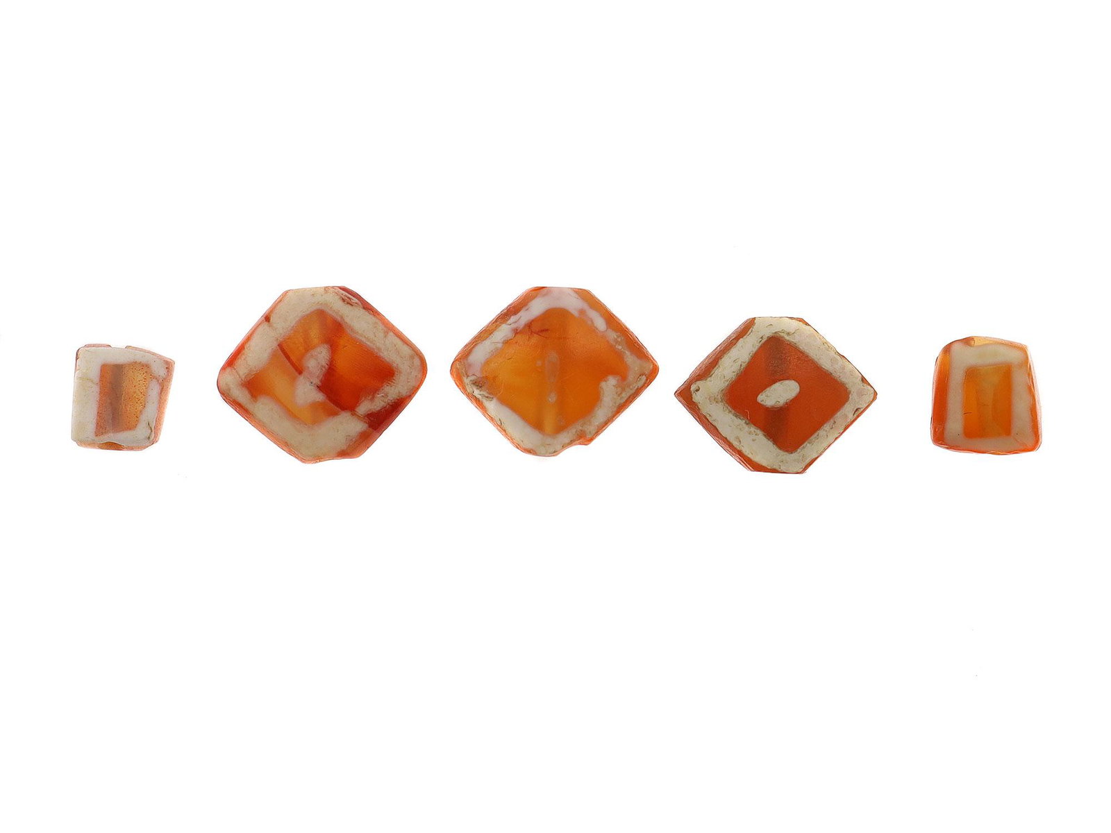WEST ASIA ETCHED CARNELIAN BEADS, 2500 BC: The art of bead etching probably began with the Indus Valley Civilization from their the art spread along the trade routes to other countries.Five flat double-sided etched carnelian beads of which thr