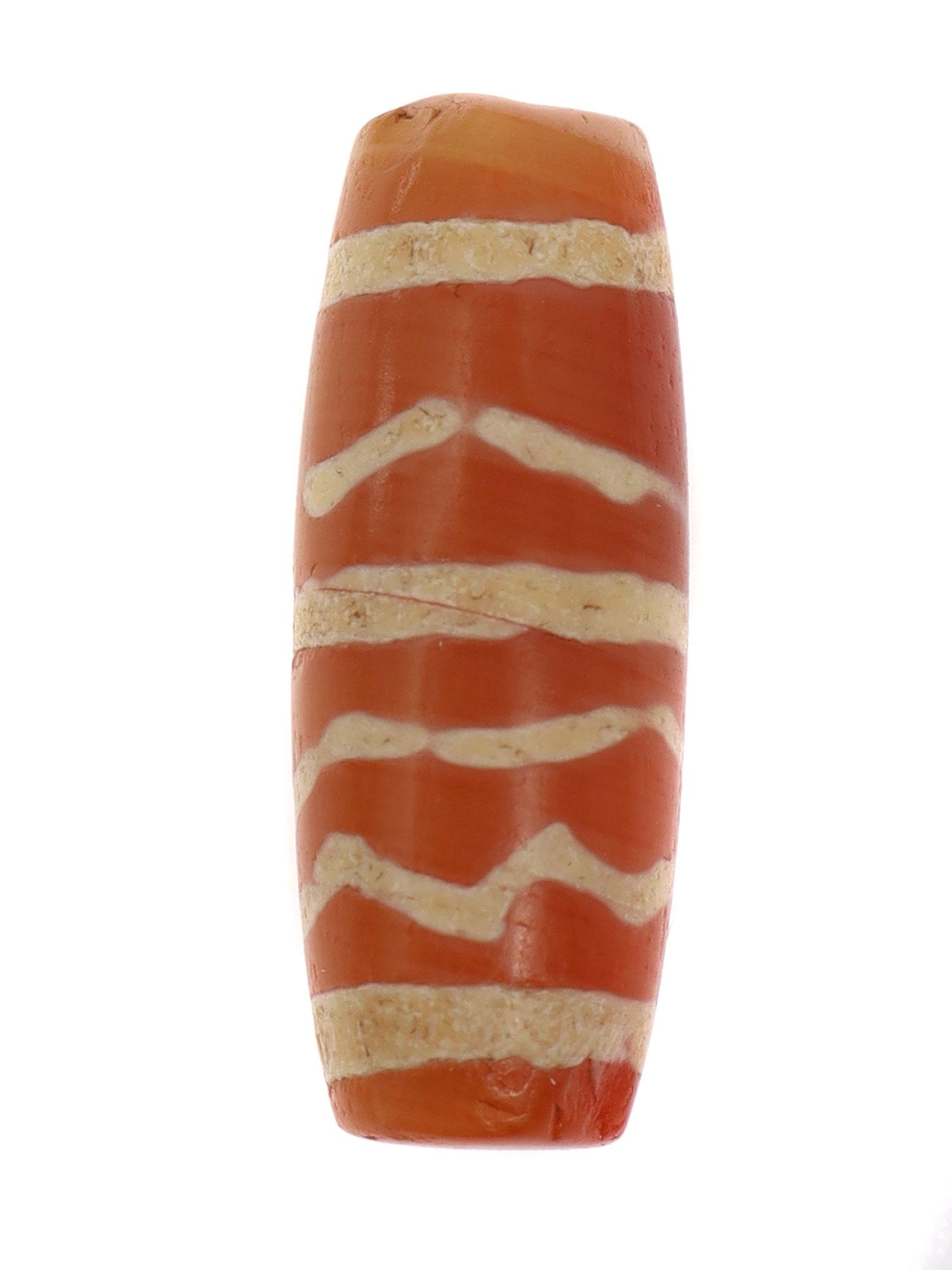 WEST ASIA ETCHED CARNELIAN BEAD, 2500 B.C.: Very rare tubular etched carnelian bead that can be found in Central Asia. The bead design depicts three stripes perpendicular the the string hole with zig-zag etchings in between. their are dzi rings