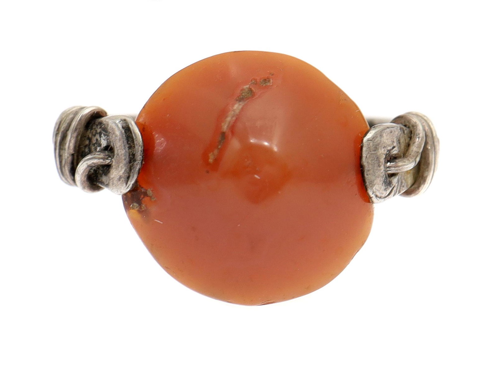 A WEST ASIA CARNELIAN BEAD SILVER RING. 3000 BC: An ancient corn-shaped etched carnelian bead on a modern silver ring with a silver wire going through the bead wraps around the shoulders. Dimensions: US: 4.5