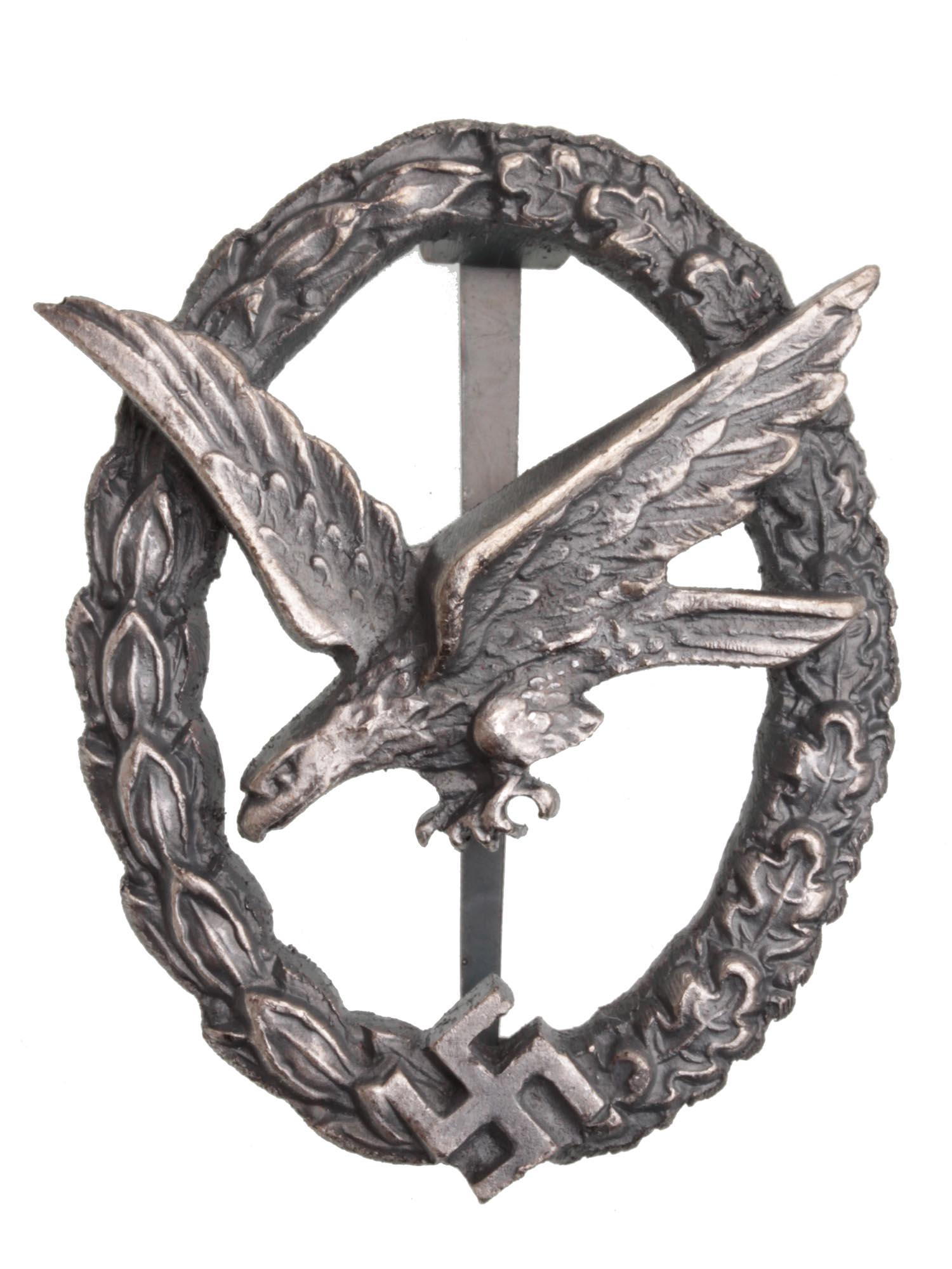 A GERMAN WWII LUFTWAFFE PARATROOPER BADGE: This is a WWII German Army Paratrooper Badge. It has a diving eagle at the center surrounded by a laurel and oak leaves wreath. The wreath has the Nazi swastika embossed at the bottom center. The Para