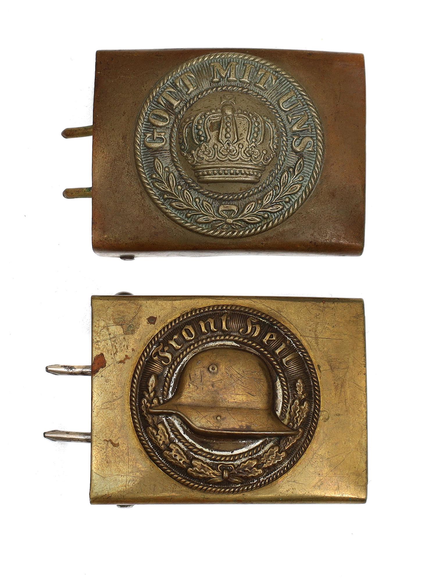 A LOT OF TWO WWI GERMAN PRUSSIAN BELT BUCKLES: Lot includes: A WWI Prussian belt buckle with the phrase "Gott Mit Uns," or in English "God Is With Us," and a German â€œFront Heil” Veteranâ€™s Association Belt Buckle. Dimensions: 2 3