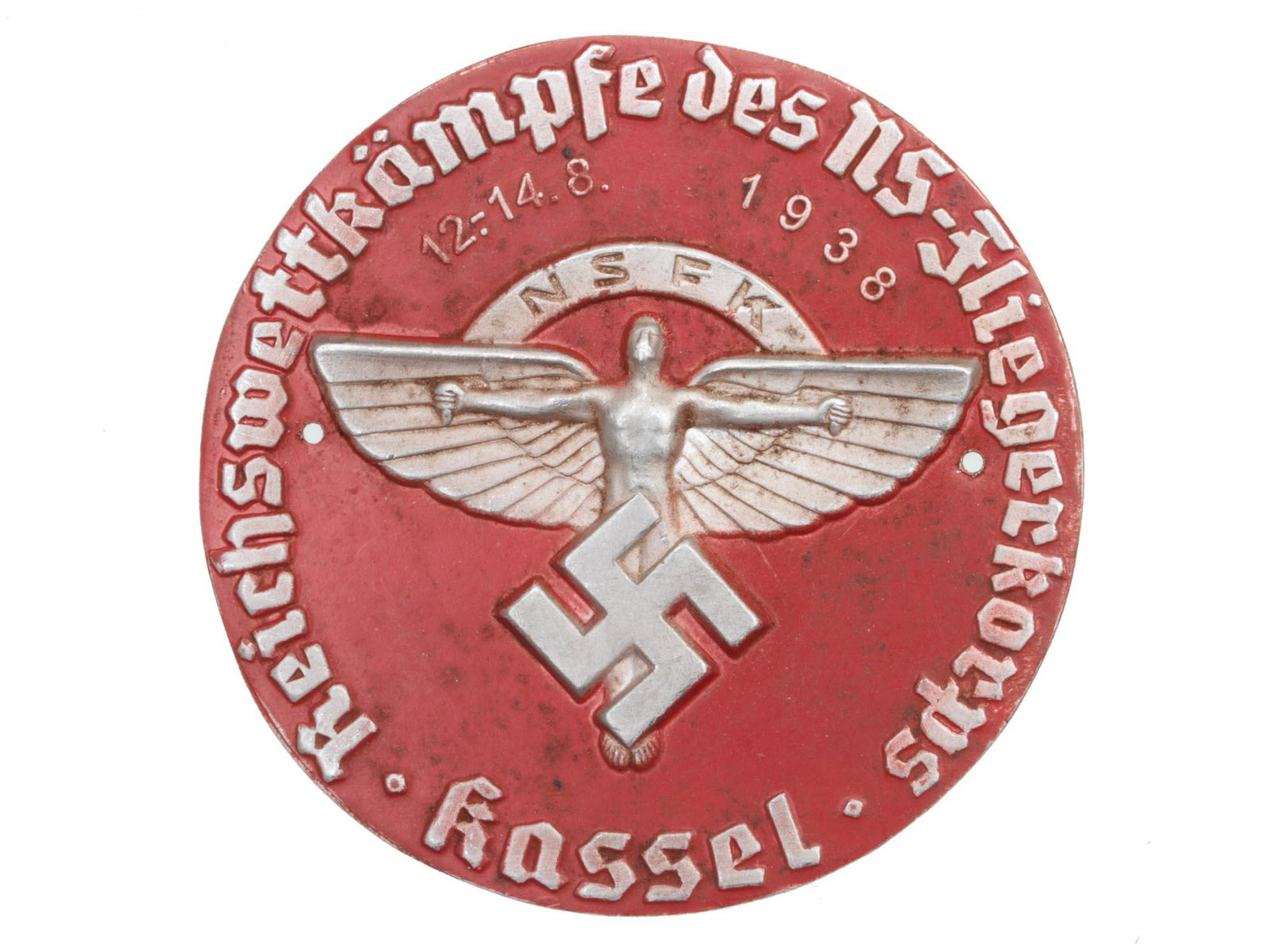 A GERMAN THIRD REICH 1938 FLYING CORPS PLAQUE: This is the 1938 National Socialist Flying Corps plaque, featuring a winged man in flight on the middle and a mobile swastika superimposed. This piece is made of aluminum with red tone accents. The bo