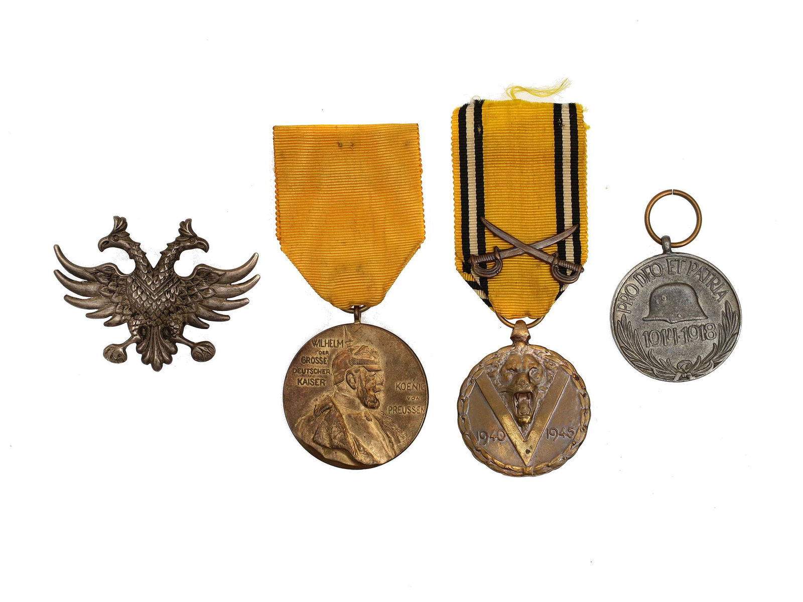 A LOT OF VARIOUS GERMANIC IMPERIAL MEDALS AND PIN: Lot includes: A Prussian "Centenary Medal," Belgian "Commemorative Medal of the 1940â€“1945 War," an Austro-Hungarian WWI Veteran medal, and a double-headed eagle pin. Dimensions: Smallest D: 1 3