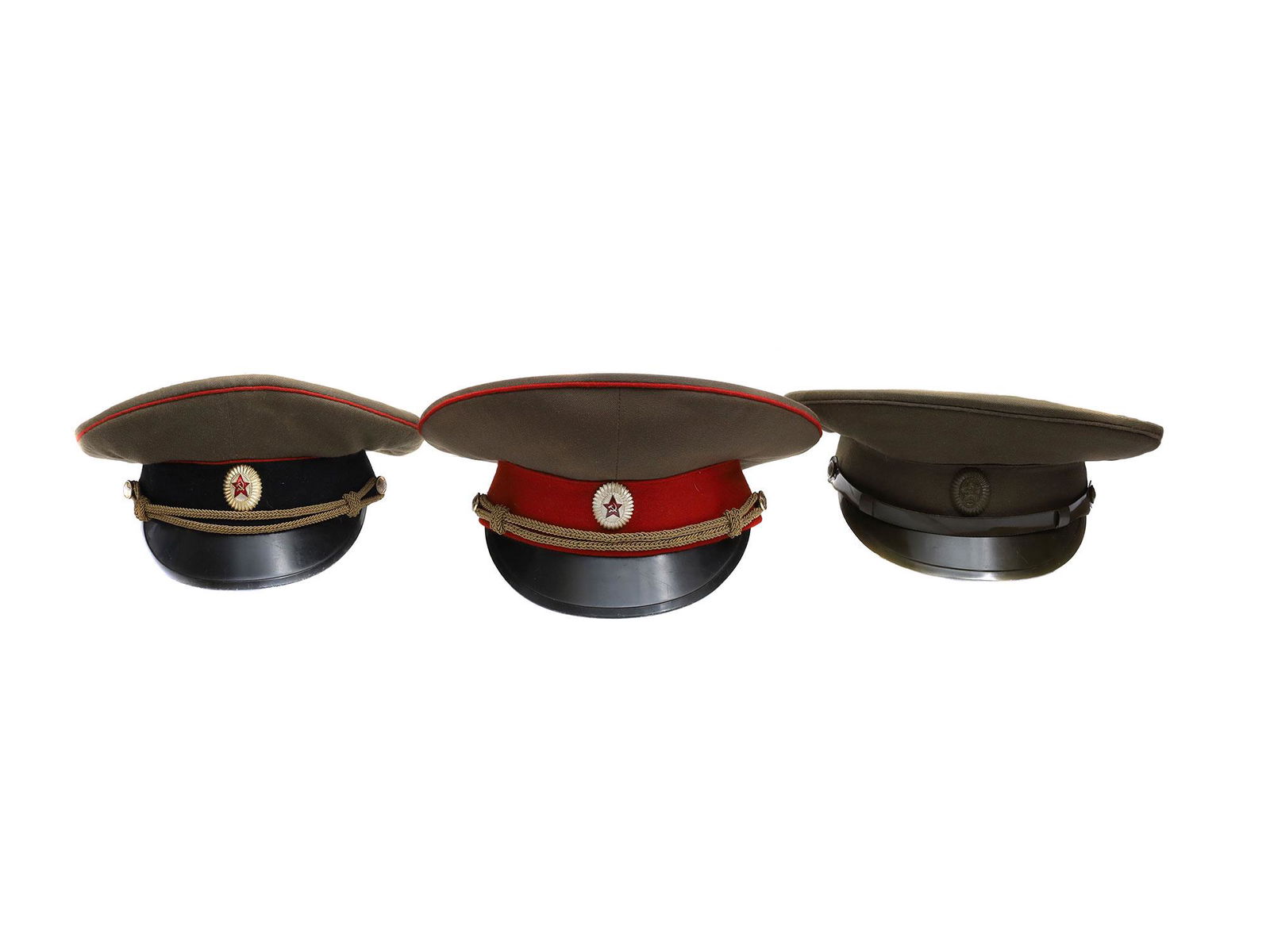 A LOT OF THREE COLD WAR ERA SOVIET OFFICER CAPS: This lot includes three Russian Soviet military visor caps, from the 70s. Includes one Infantry Division, Armored Division, and one General's field caps. Dimensions: Green hat size: 58