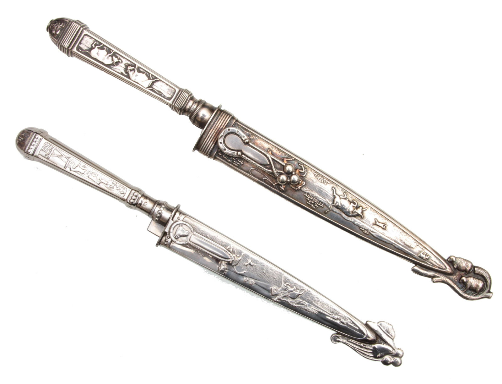 A PAIR OF ORNATE ARGENTINIAN GAUCHO KNIVES: This lot includes a pair of attractive ornate Gaucho knives with a scabbard. The first knife has a great display blade with countryside decorations, the sheath has very nice embossed roping scenes, th