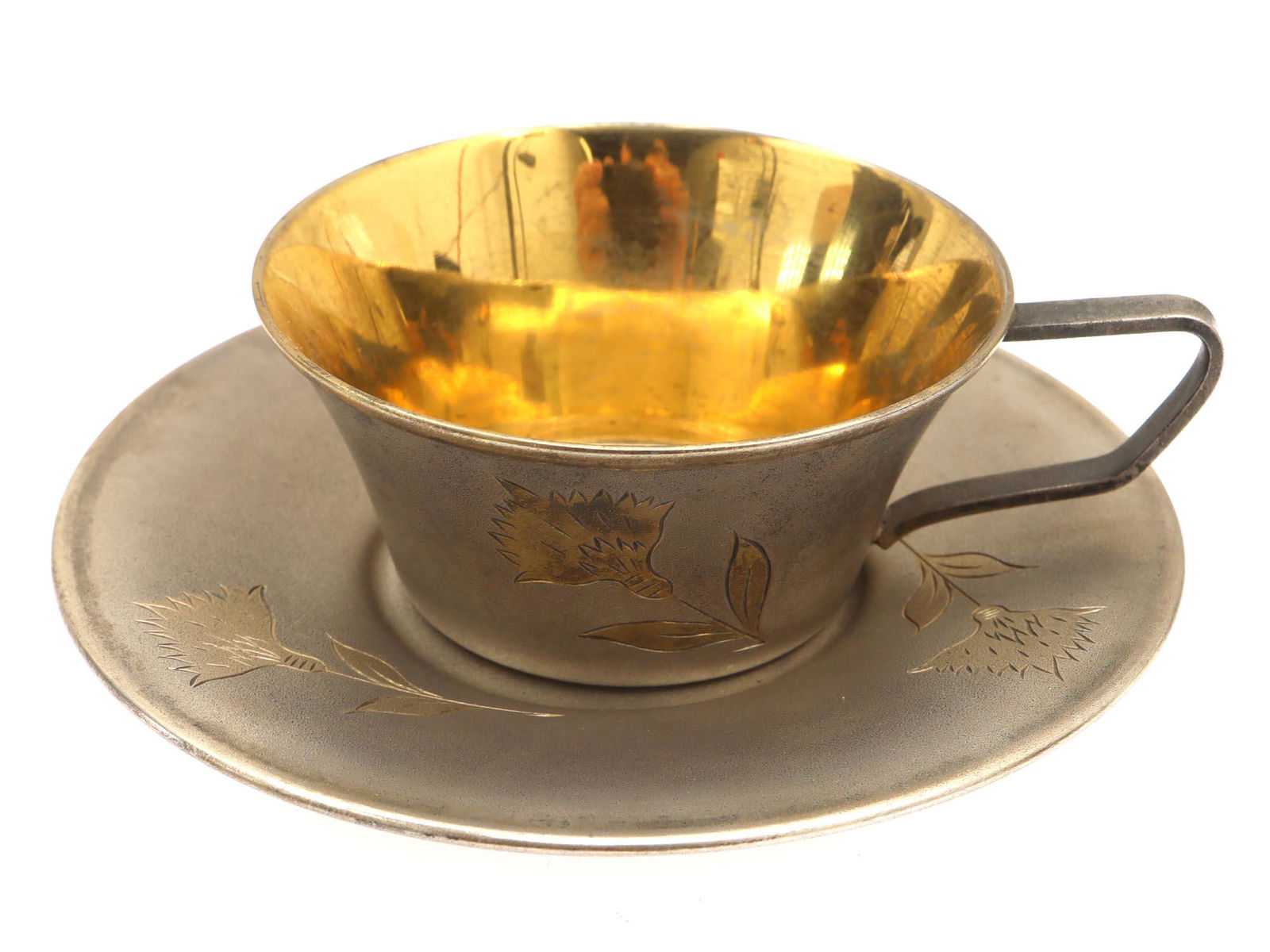 A VINTAGE RUSSIAN GILT SILVER CUP AND SAUCER SET: A vintage Russian Soviet gilt-silver cup and saucer tea set. The surface is decorated with engraved flowers. On the bottom, there are engraved initials "LI" (Cyrillic). Hallmarked with an 875 silver s