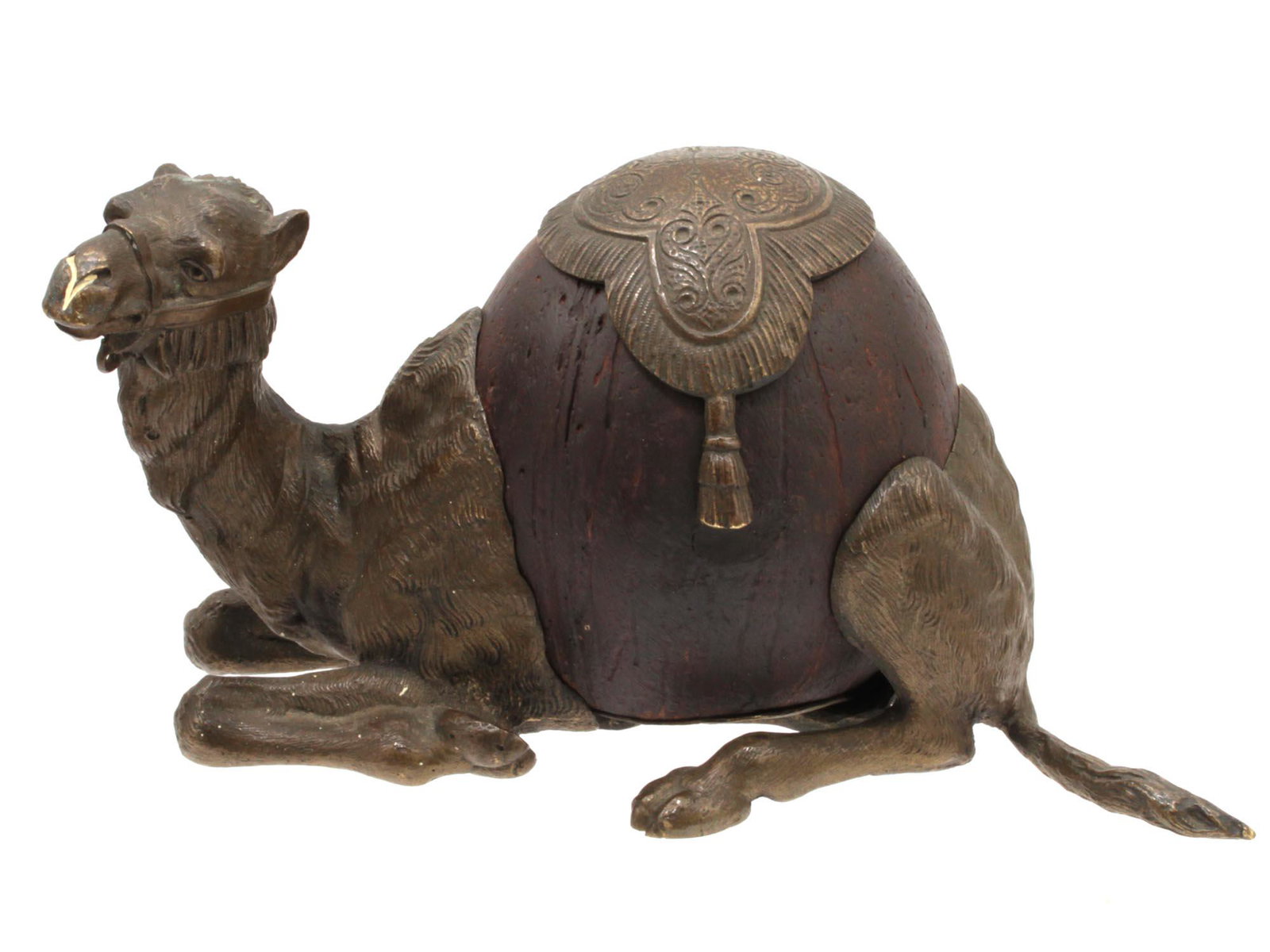 A VIENNA BRONZE CAMEL WITH COCONUT, 19TH C.: An antique bronze inkwell in the form of a recumbent camel with a polished coconut body. The inkwell lid is made in the shape of a saddle with tassels and a fringe. Inside the inkwell is gilded, and t