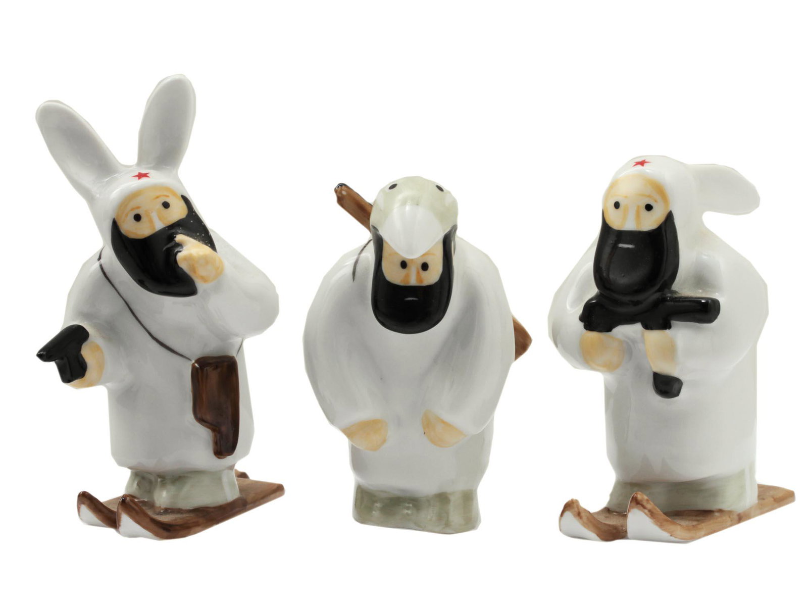 A SET OF THREE RUSSIAN PORCELAIN FIGURINES: Three Russian porcelain figurines from the limited edition series "Russian Partizan" by the artist Vasily Golubev. LFZ Factory, St. Petersburg. The first figurine depicts a partisan on skis in a hare 