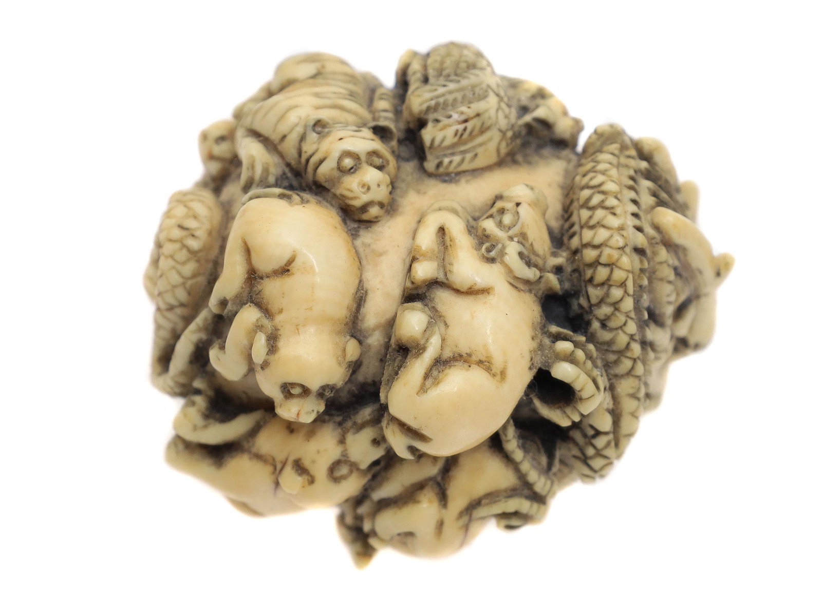 A VINTAGE JAPANESE CARVED NETSUKE OKIMONO: A Meiji period vintage Japanese carved okimono depicting zodiac animals. The bodies of animals are intertwined with each other, obeying the general spherical shape of the okimono. Dimensions: H: 1 1/1