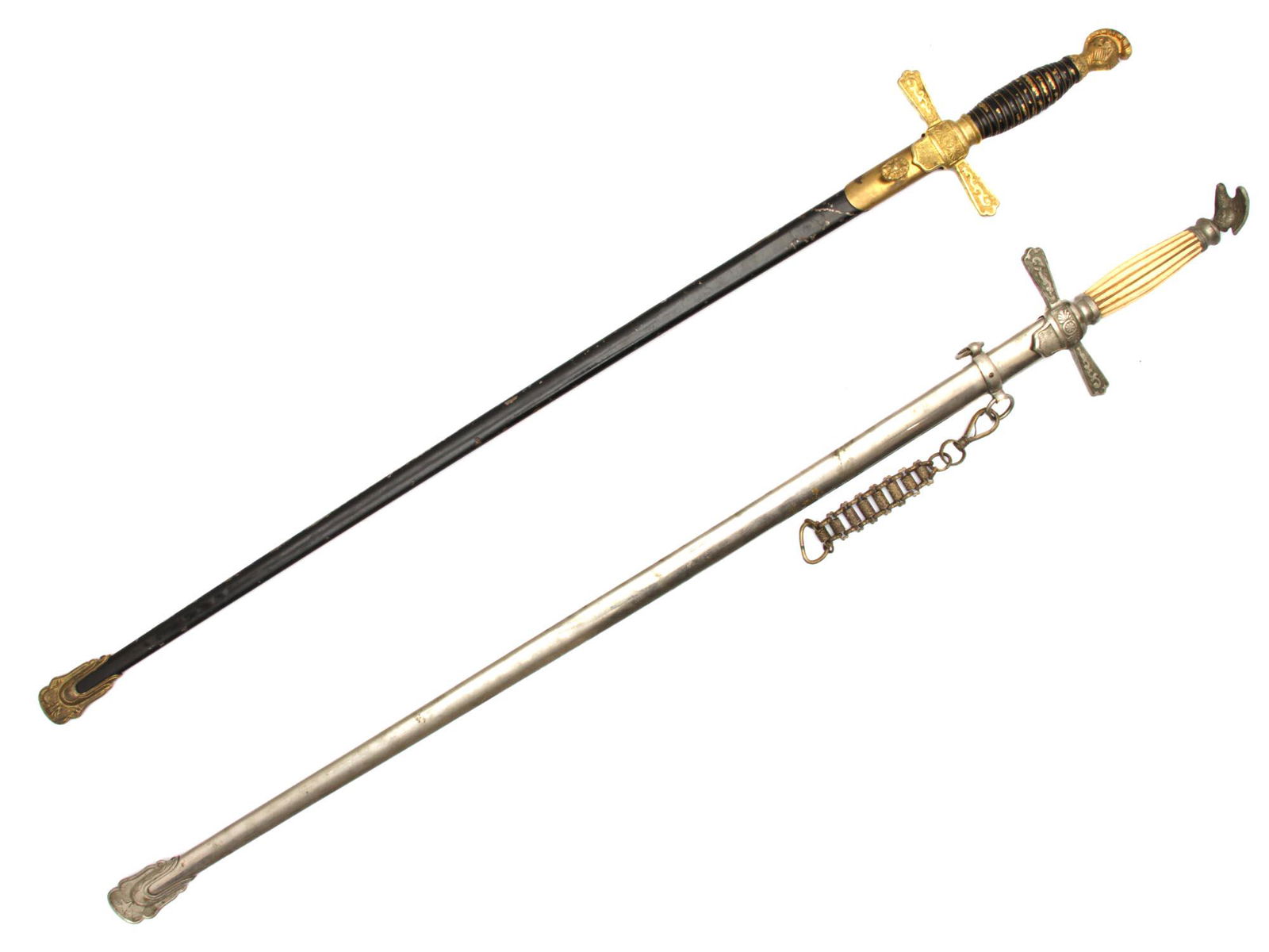 TWO MASONIC CEREMONIAL SWORDS: A pair of Masonic swords, the first sword features a black handle with a gilded cross guard and a knight helmet pommel. The fine blade is unmarked and the nickel scabbard has been painted in black and