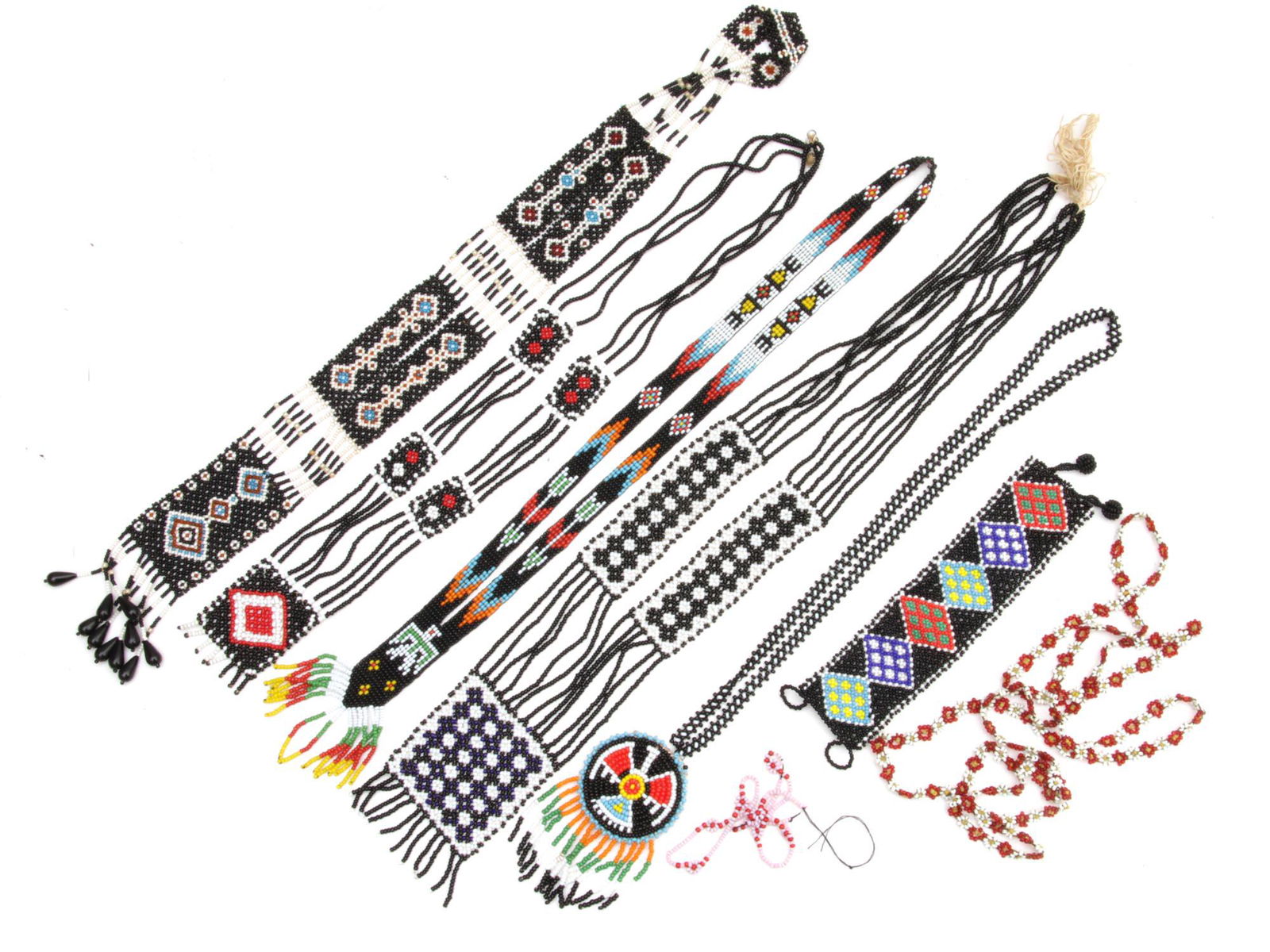 A LOT OF SEVEN BEADED NATIVE AMERICAN ITEMS: This lot includes 7 Native American items. These beautiful pieces are handmade and crafted with colorful Southwest designs of floral motifs, the American Eagle, and various patterns. Dimensions: Small