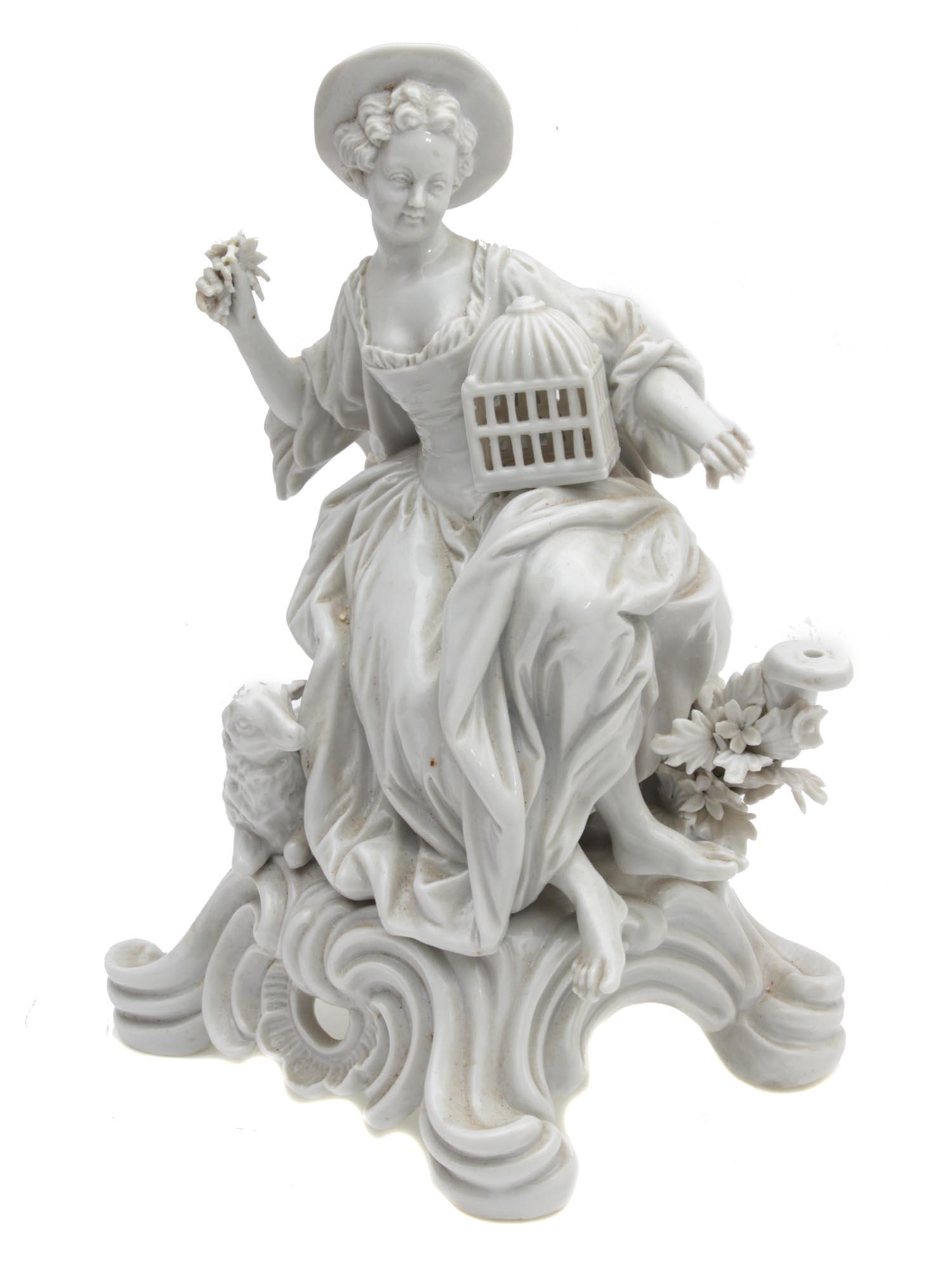 AN ANTIQUE PORCELAIN ROCOCO STYLE FIGURINE: A beautiful 19th-century porcelain figurine depicting a lady with a bird's cage and a little sheep beside her legs. All details are perfectly worked out, including thin lace at the neckline and folds 