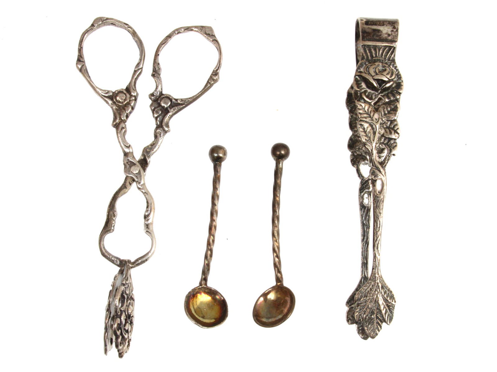 A LOT OF FOUR VARIOUS ANTIQUE SILVERWARE UTENSILS: Lot includes 4 antique Berlin-made silverware utensils, including 2 scissor tongs and 2 small silver spoons. Marked "Antiko 800"Silver weight: 44.5 g. Dimensions: Smallest L: 2 in. Largest L: 4 in.