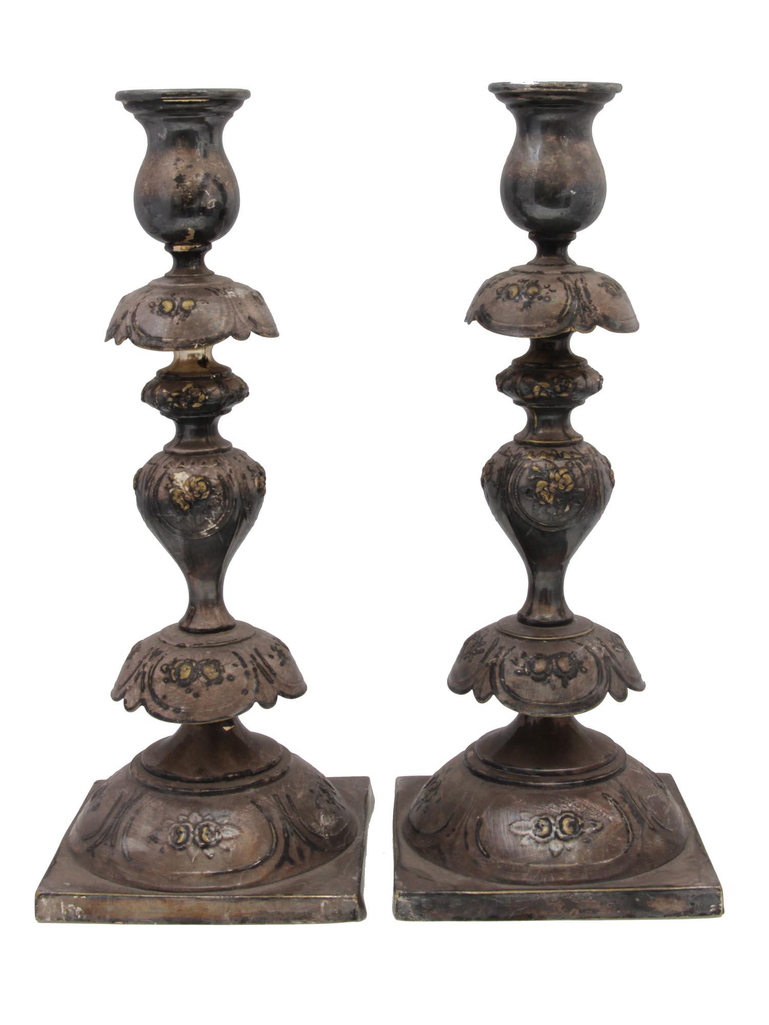 A RUSSIAN ANTIQUE SILVER PLATED CANDLESTICKS: A pair of antique silver-plated brass Shabbat candlesticks by Norblin & Co GALW Warszawa. Candlestick with baluster-shaped decorations and embossed floral patterns. Marked on the base with the manufac