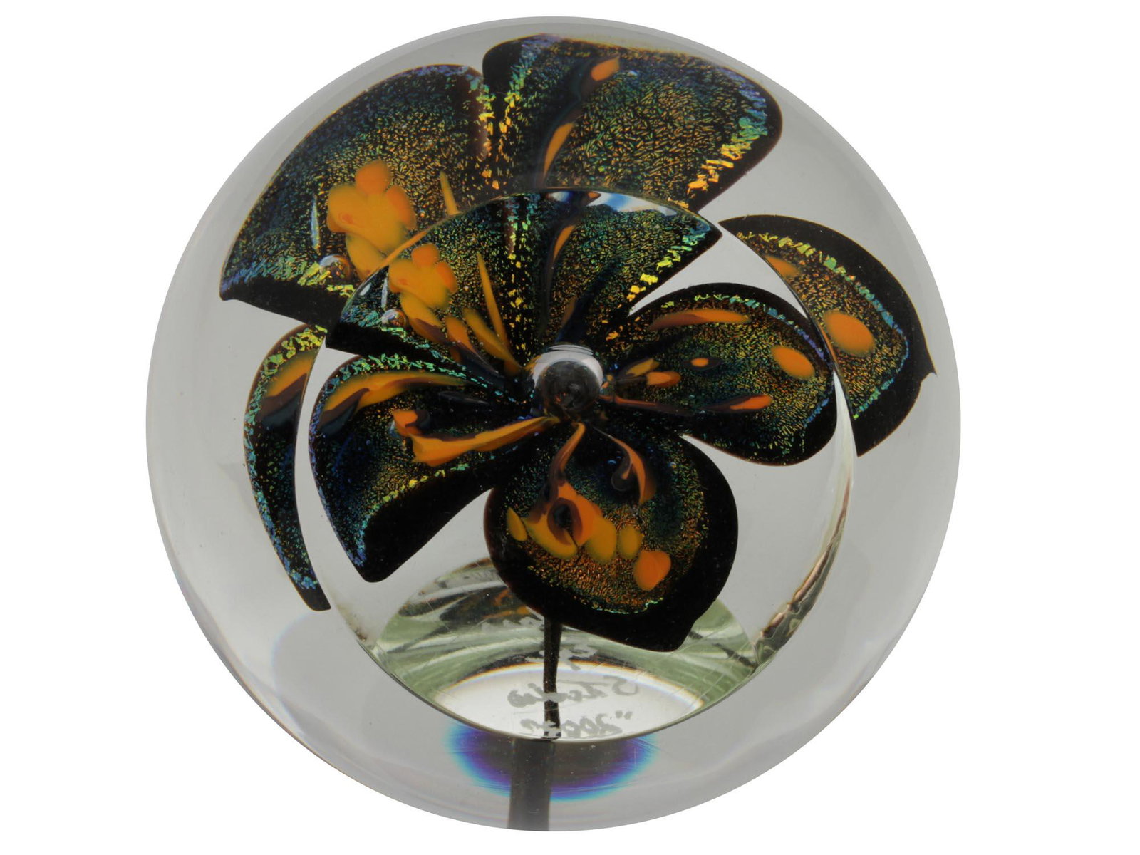 A COLLECTIBLE GLASS EYE STUDIO PAPERWEIGHT: A very beautiful hand-blown collectible paperweight from Glass Eye Studio. Round in shape, with one flat side and a flat base. There is a voluminous flower inside, the petals of which shimmer in diffe